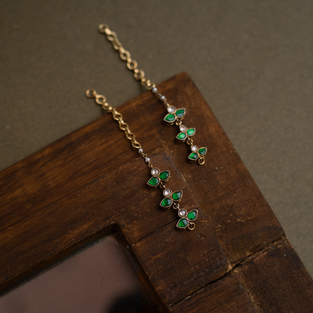 Kundan Collection ear chain with white and green kundan stones in a delicate floral design.