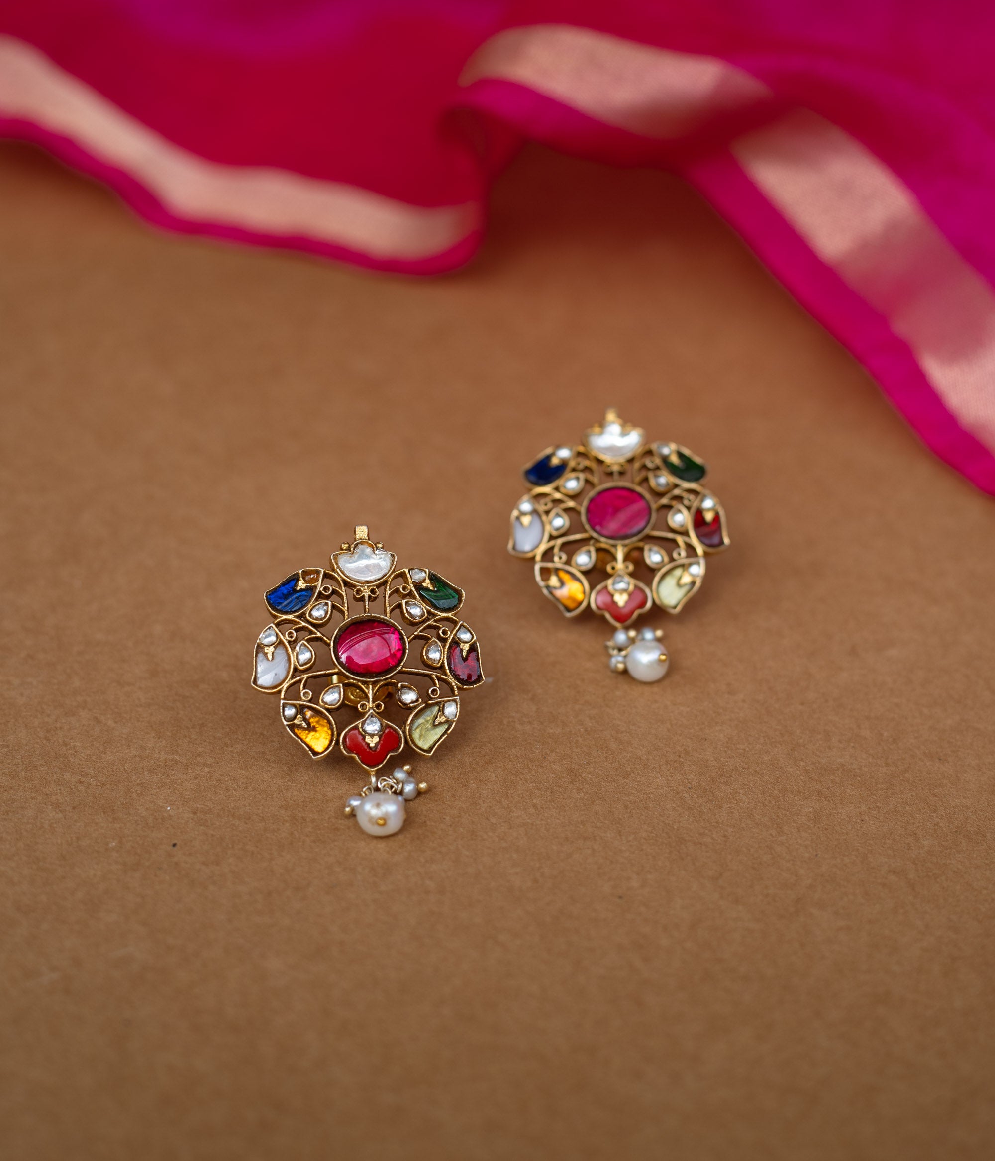 Floral Kundan earrings with a white Kundan design and a single pearl drop.