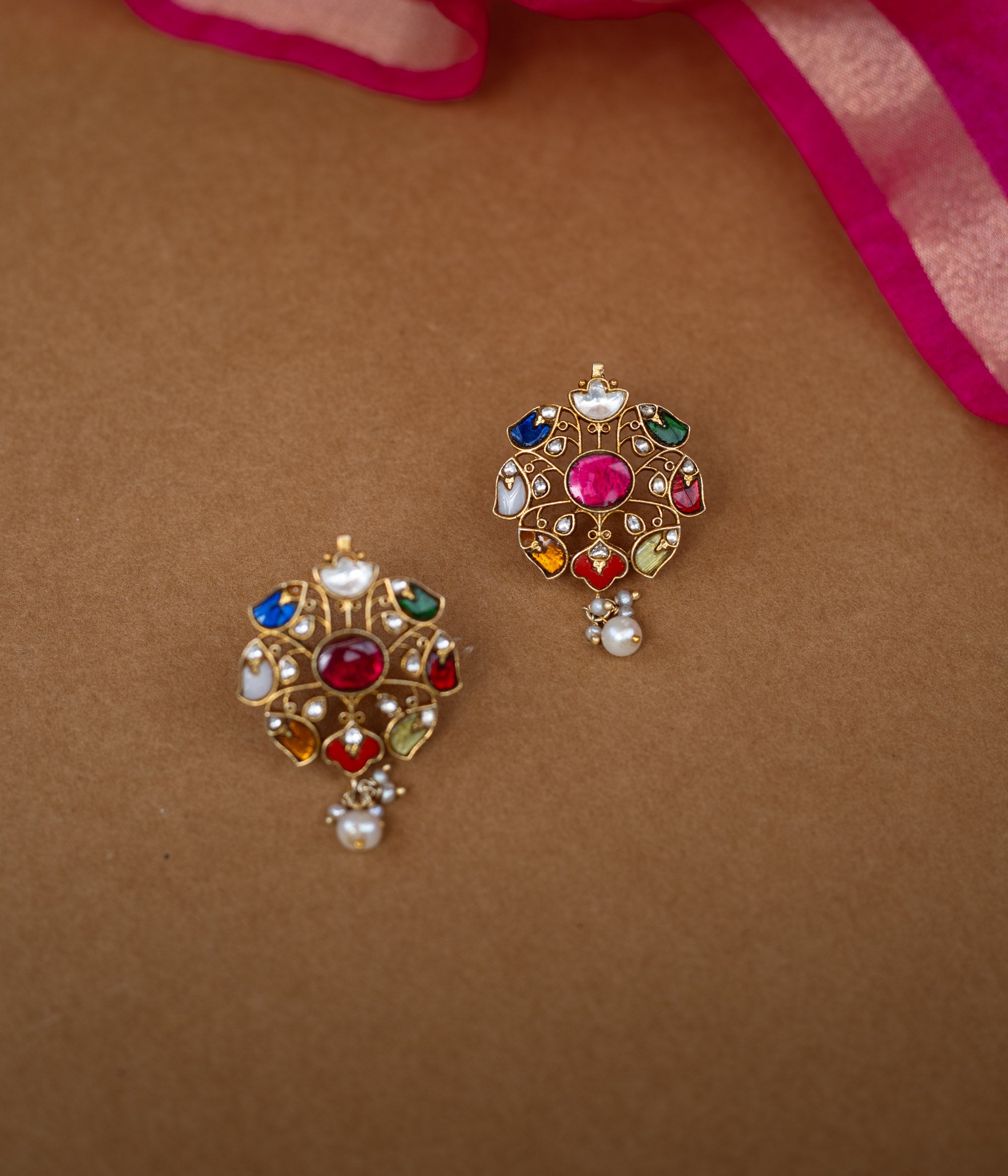 Floral Kundan earrings with a white Kundan design and a single pearl drop.