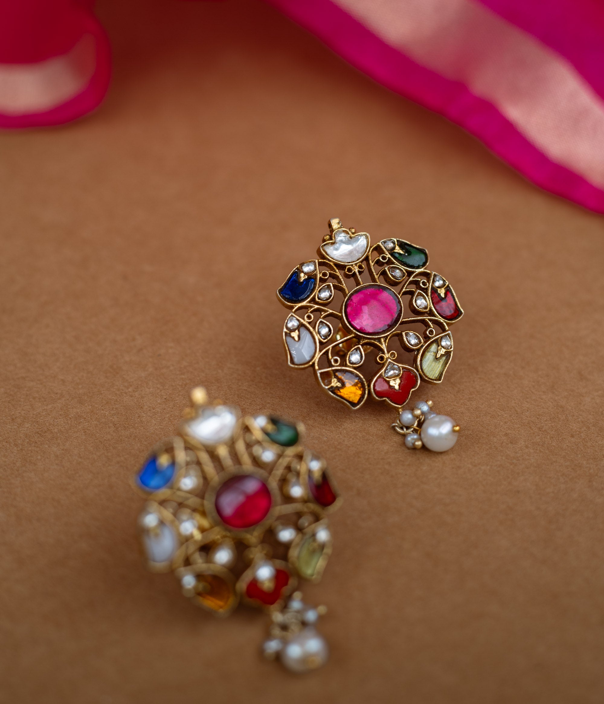 Floral Kundan earrings with a white Kundan design and a single pearl drop.