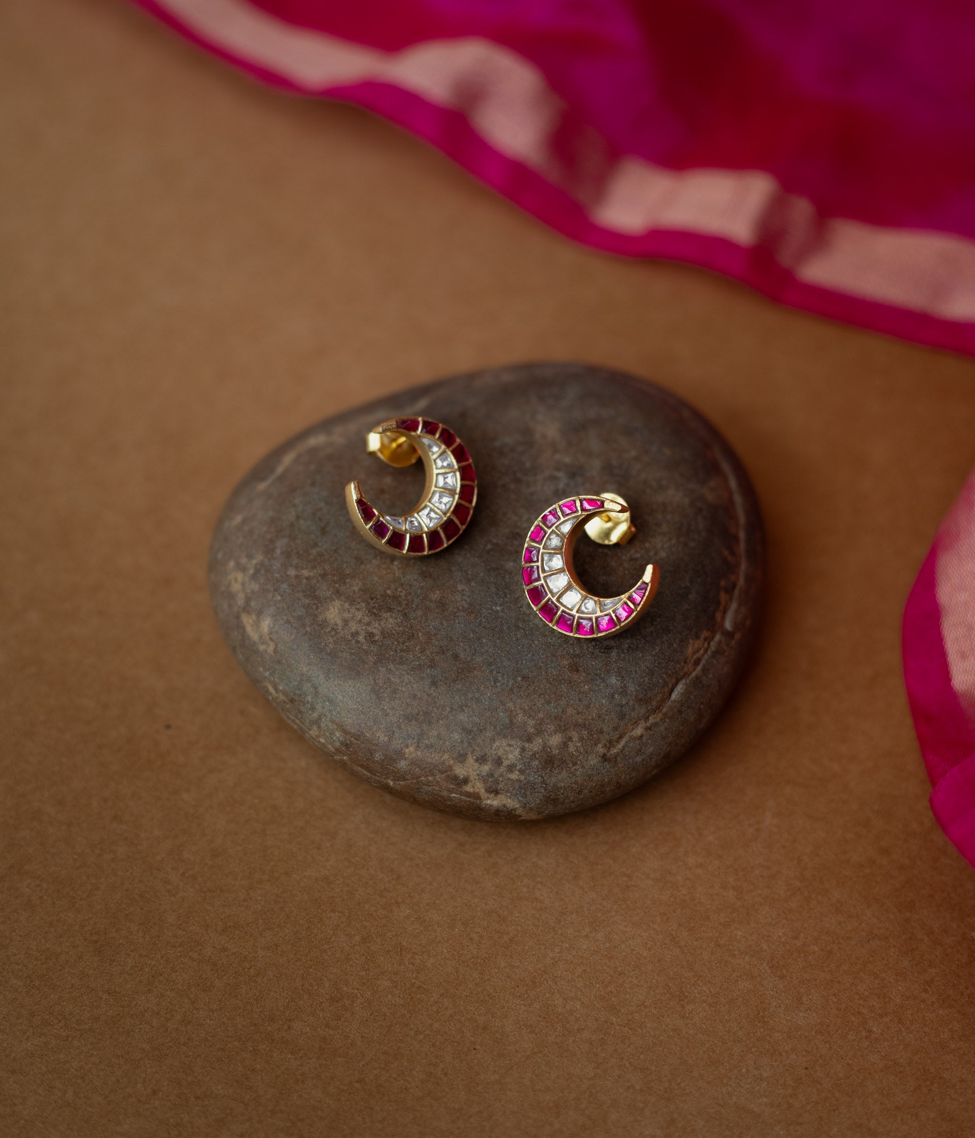 Gold crescent earrings adorned with red and white Kundan stones from Kundan Collection, exuding regal moonlit charm.