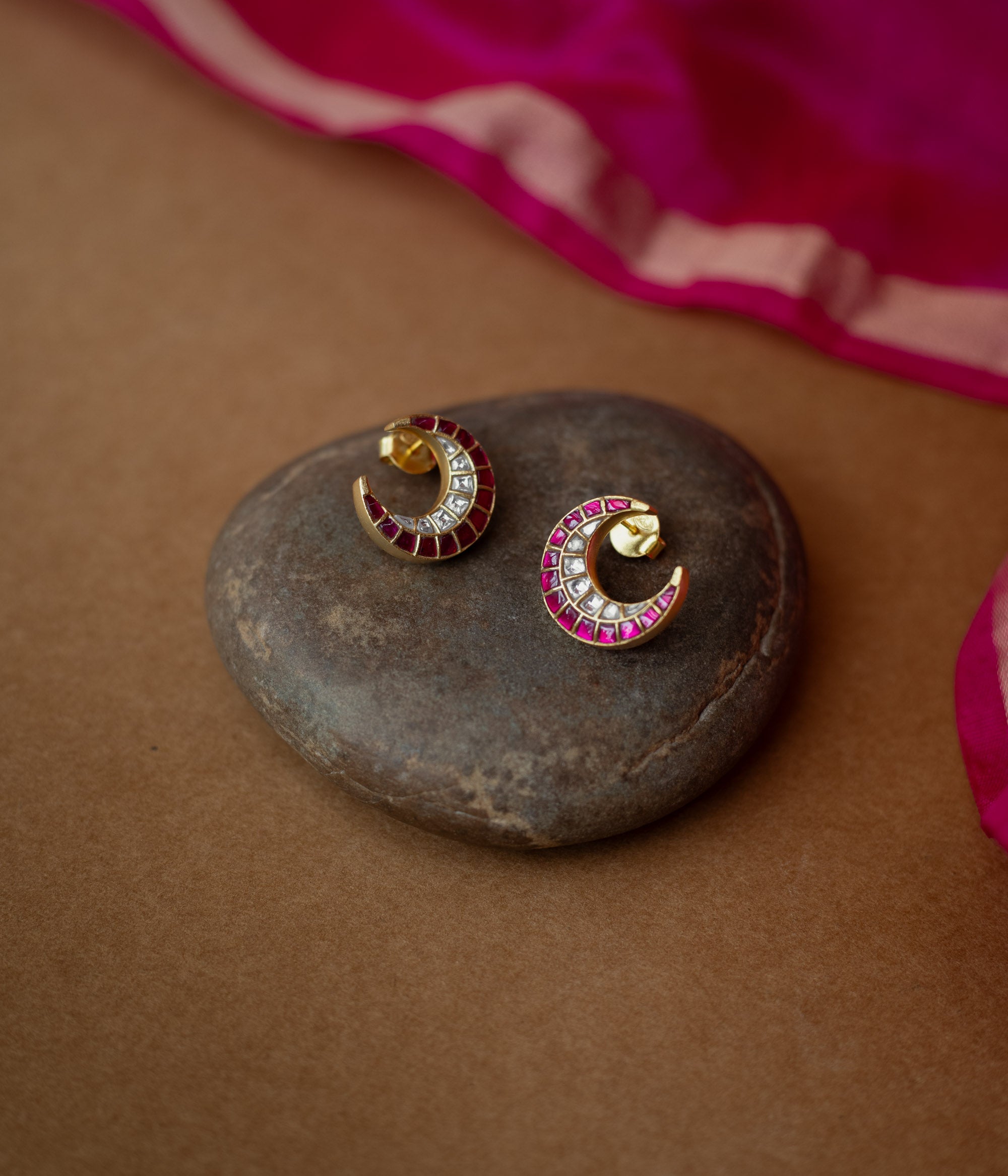 Gold crescent earrings adorned with red and white Kundan stones from Kundan Collection, exuding regal moonlit charm.
