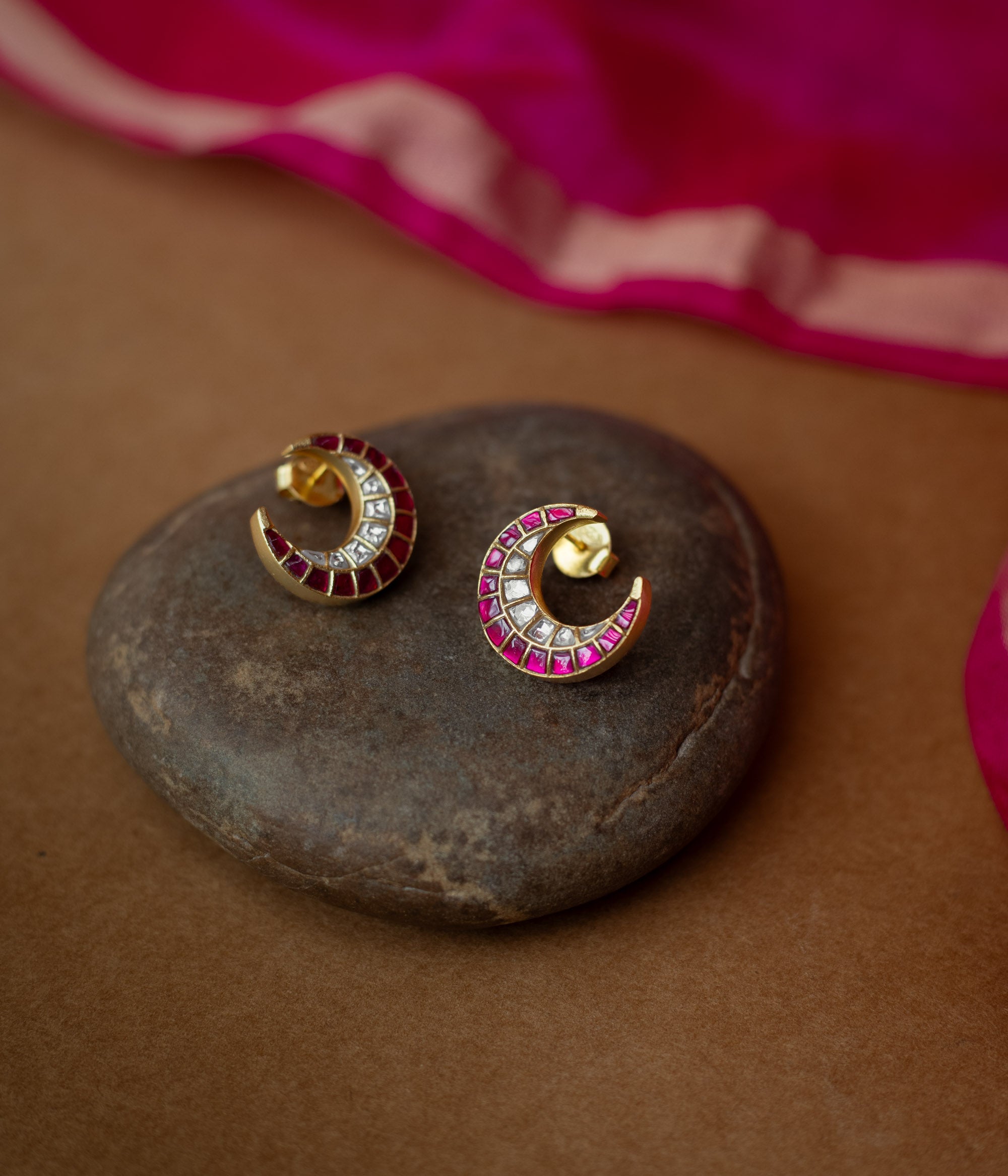 Gold crescent earrings adorned with red and white Kundan stones from Kundan Collection, exuding regal moonlit charm.