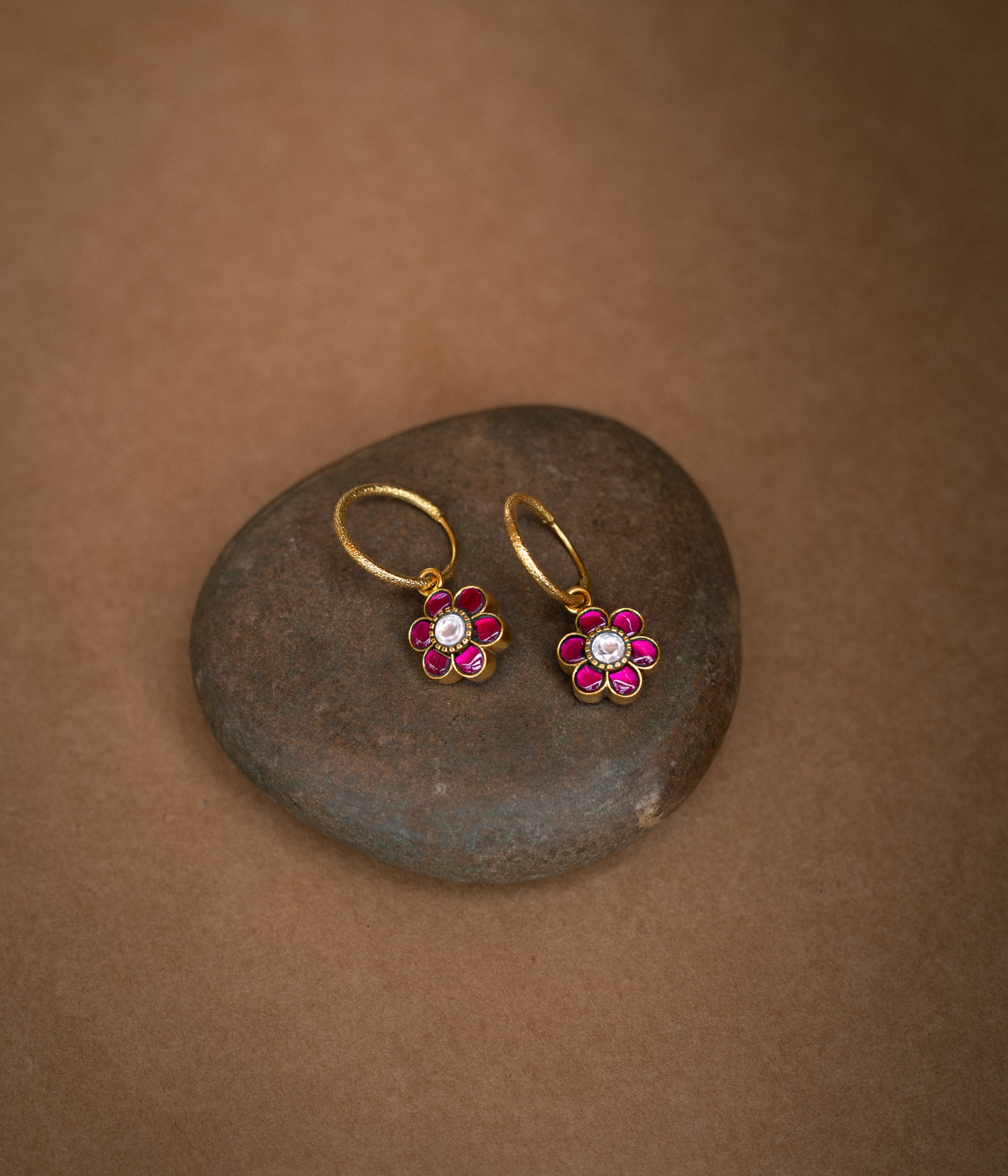 Floral-shaped reversible earrings with red and green Kundan stones from Kundan Collection.