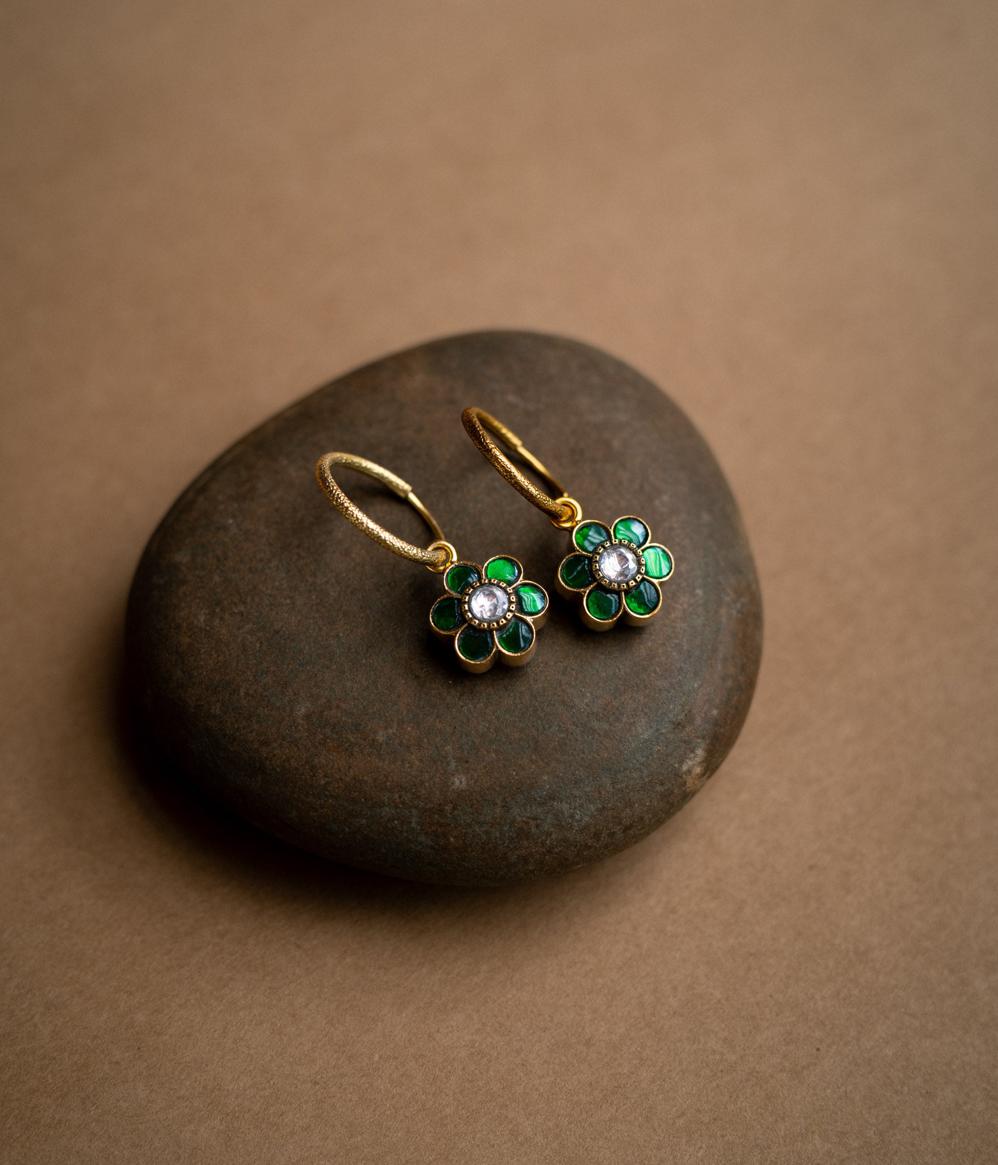 Floral-shaped reversible earrings with red and green Kundan stones from Kundan Collection.
