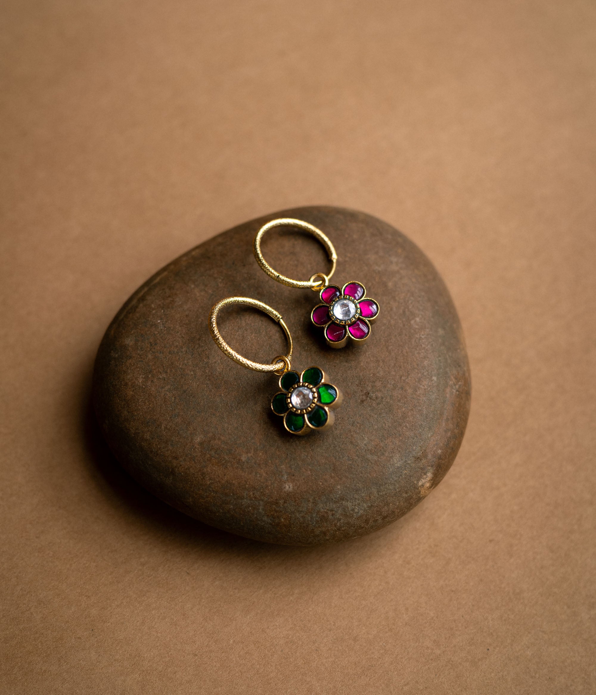 Floral-shaped reversible earrings with red and green Kundan stones from Kundan Collection.