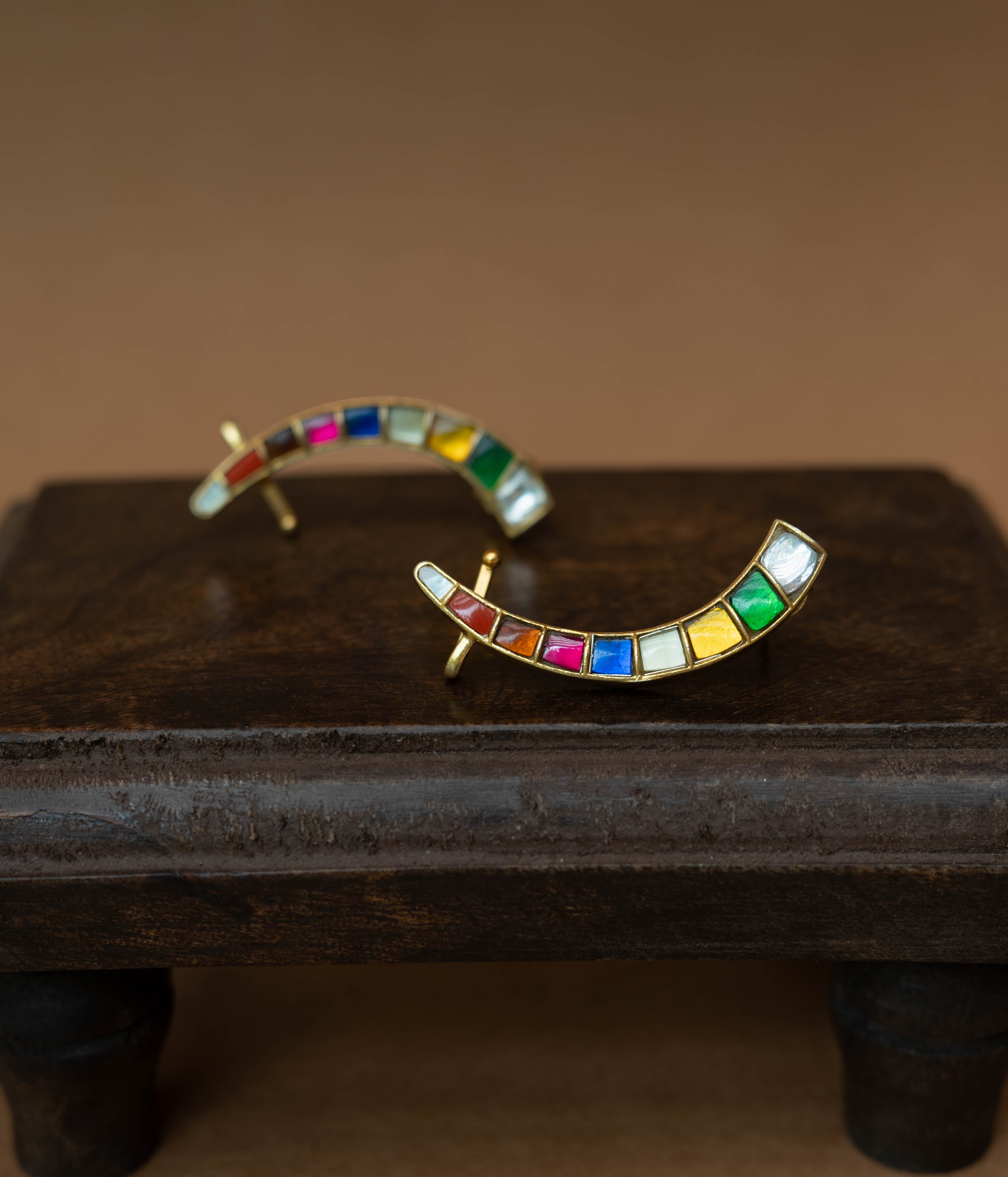Curved ear crawlers with a row of multi-colored square stones.