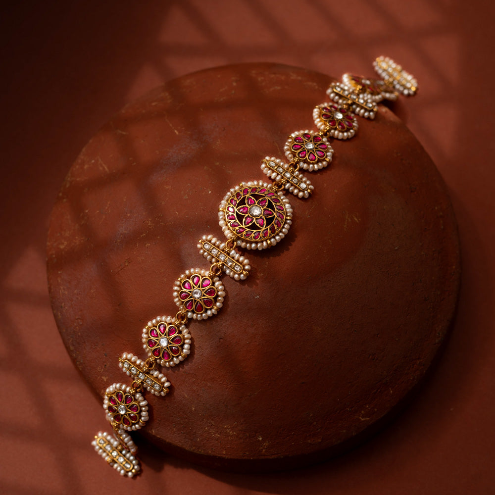 Stunning 92.5 sterling silver Rangoli Radiance Pearl Mathapatti inspired by festive rangoli patterns, crafted with circular ruby red and kundan stone motifs bordered by delicate pearls, perfect for bridal looks, temple ceremonies, or cultural festivities, blending elegance with heritage.