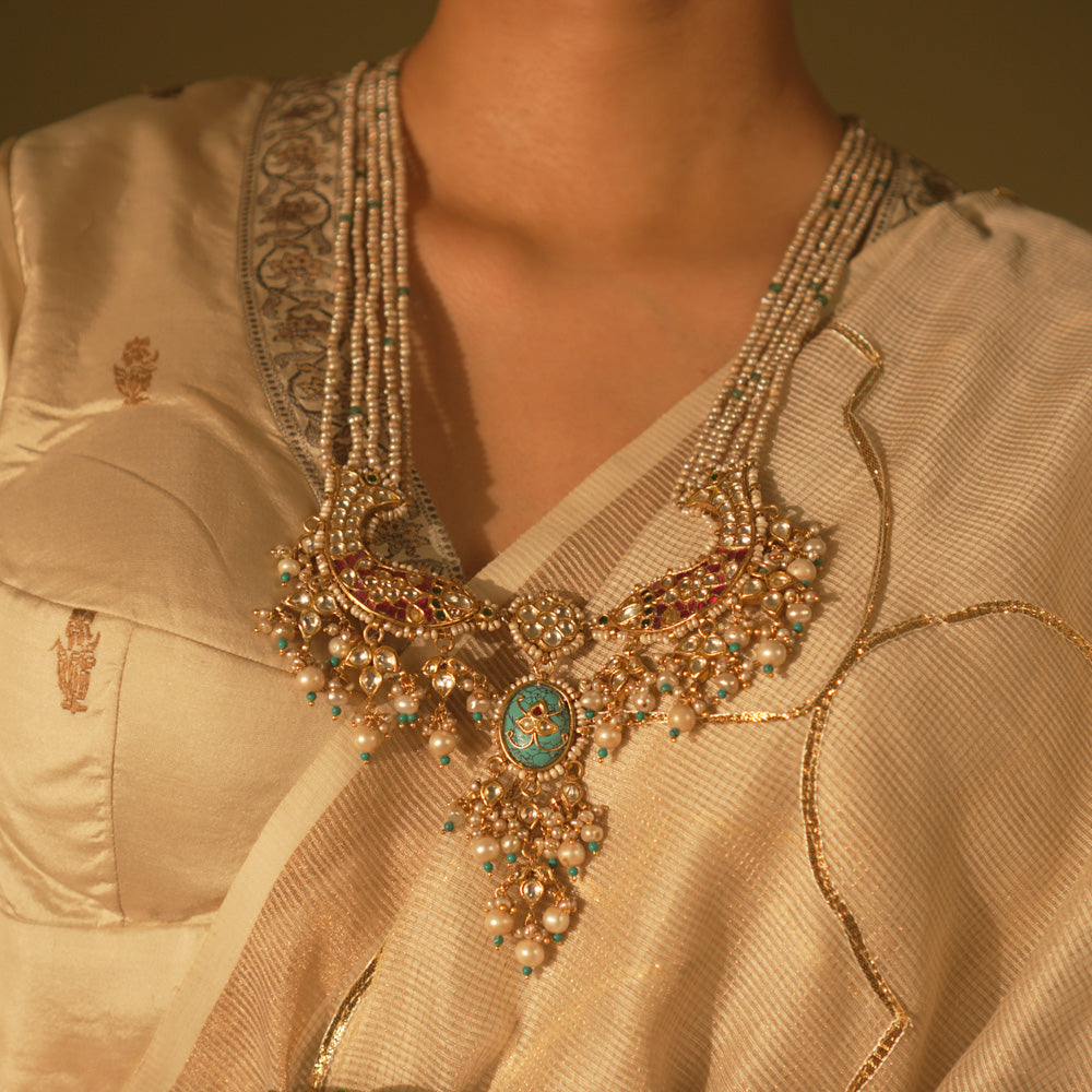  Gold-veiled silver necklace with abstract fish motifs, pearls, and Kundan stones—blending heritage, ocean lore, and artistry.