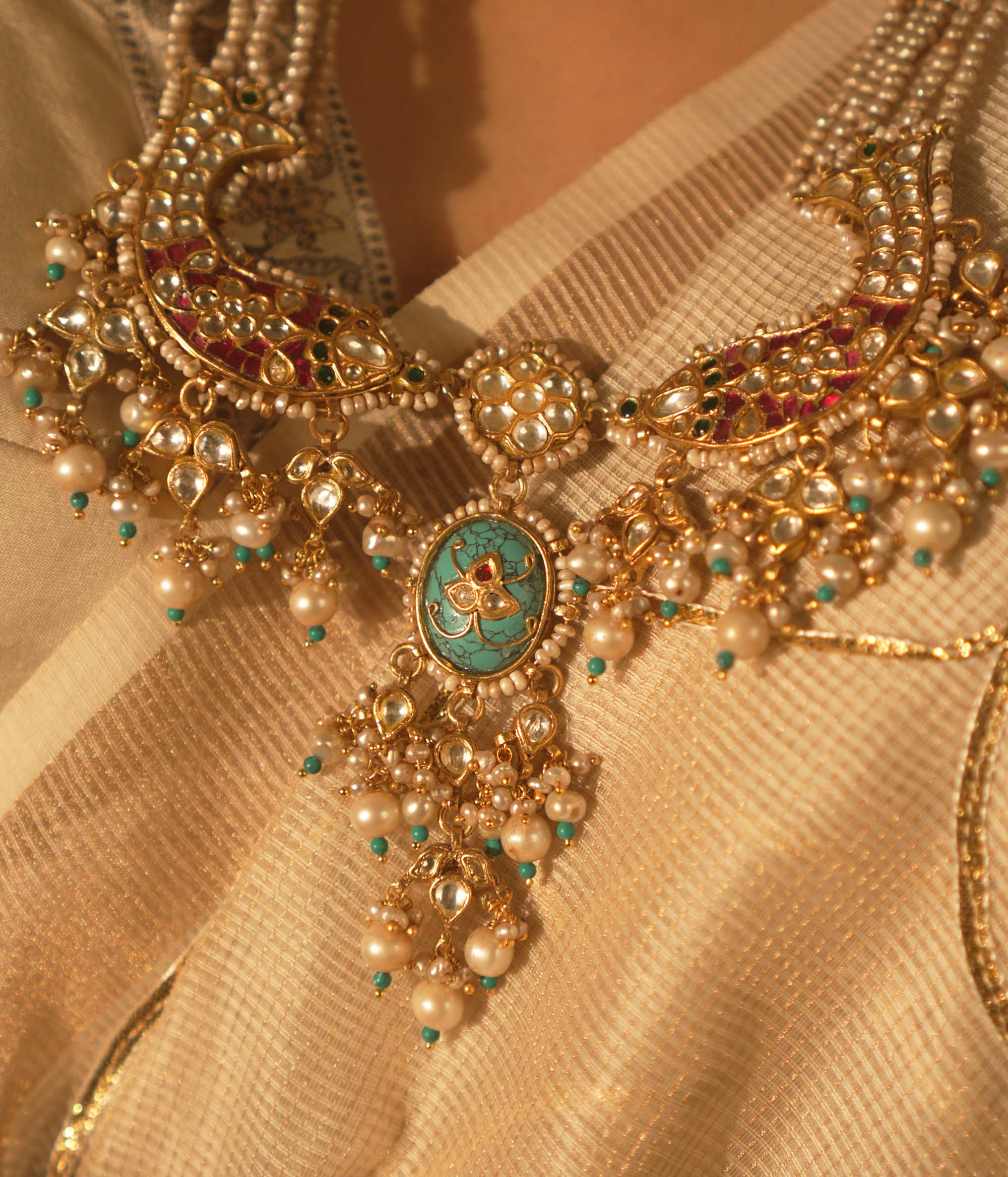  Gold-veiled silver necklace with abstract fish motifs, pearls, and Kundan stones—blending heritage, ocean lore, and artistry.