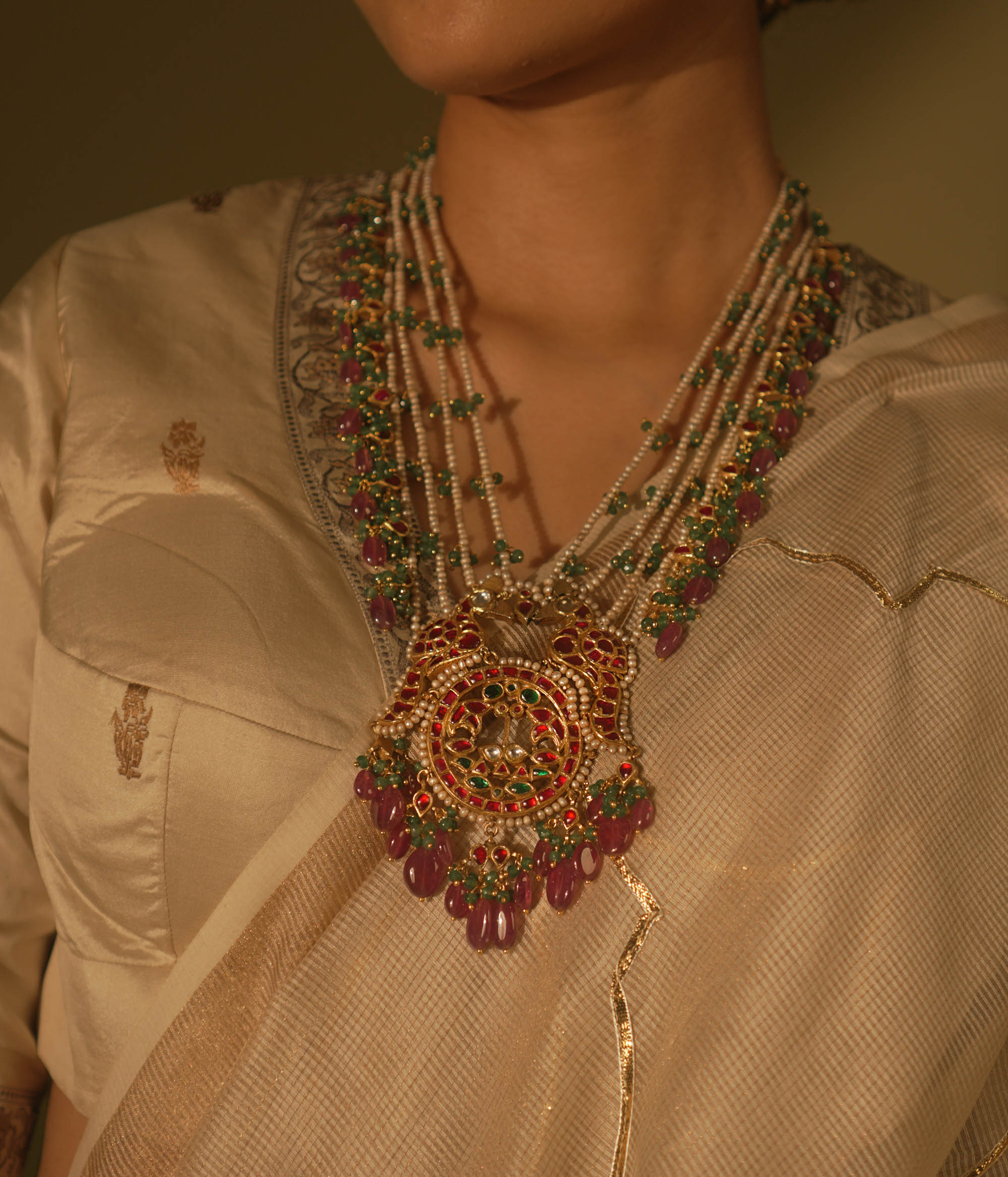 Garden-inspired necklace with pink-green Kundan and pearls—nature’s beauty woven into fine jewelry.