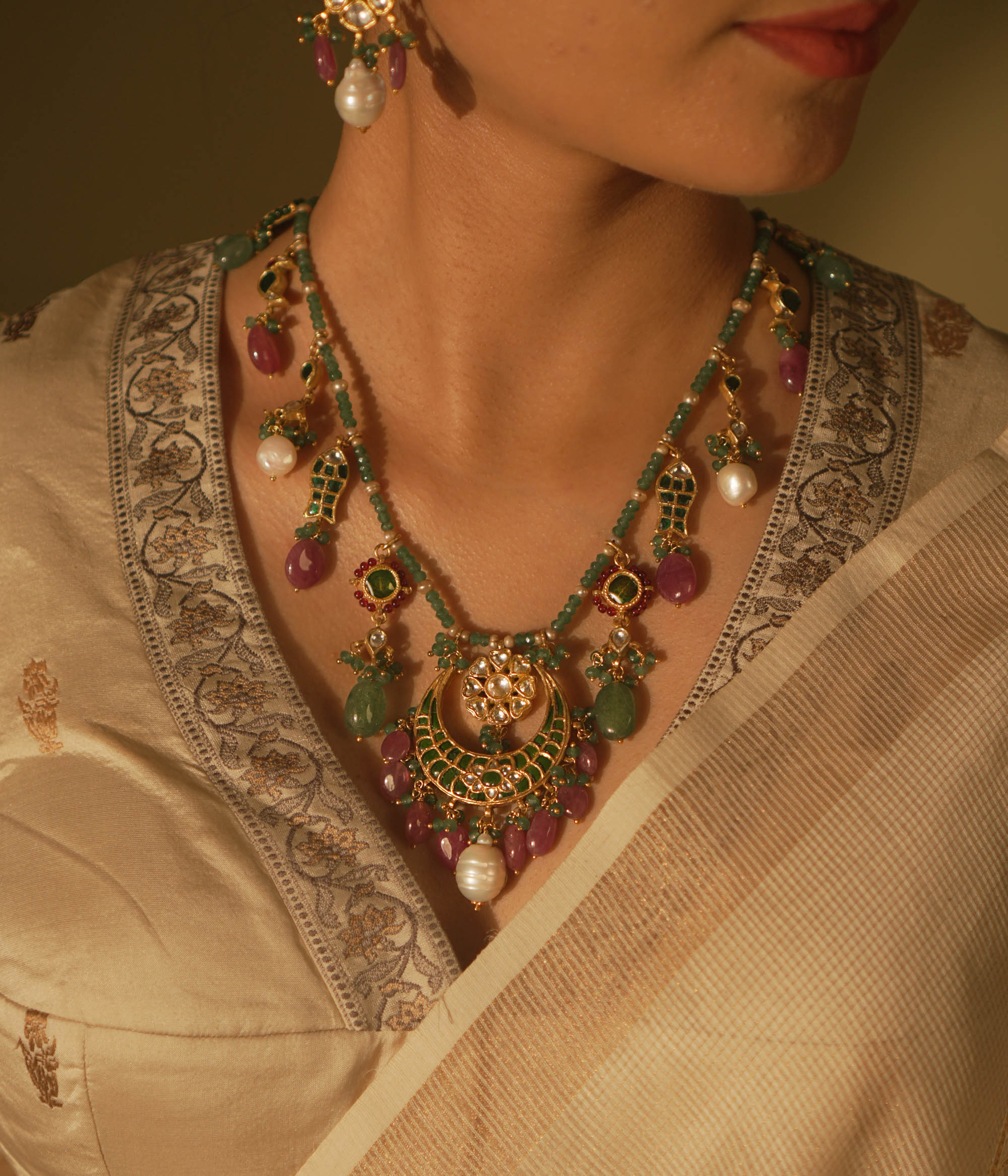  Regal heritage necklace with green stones, pearls, and enamel jhumka pendant—perfect for bridal elegance.