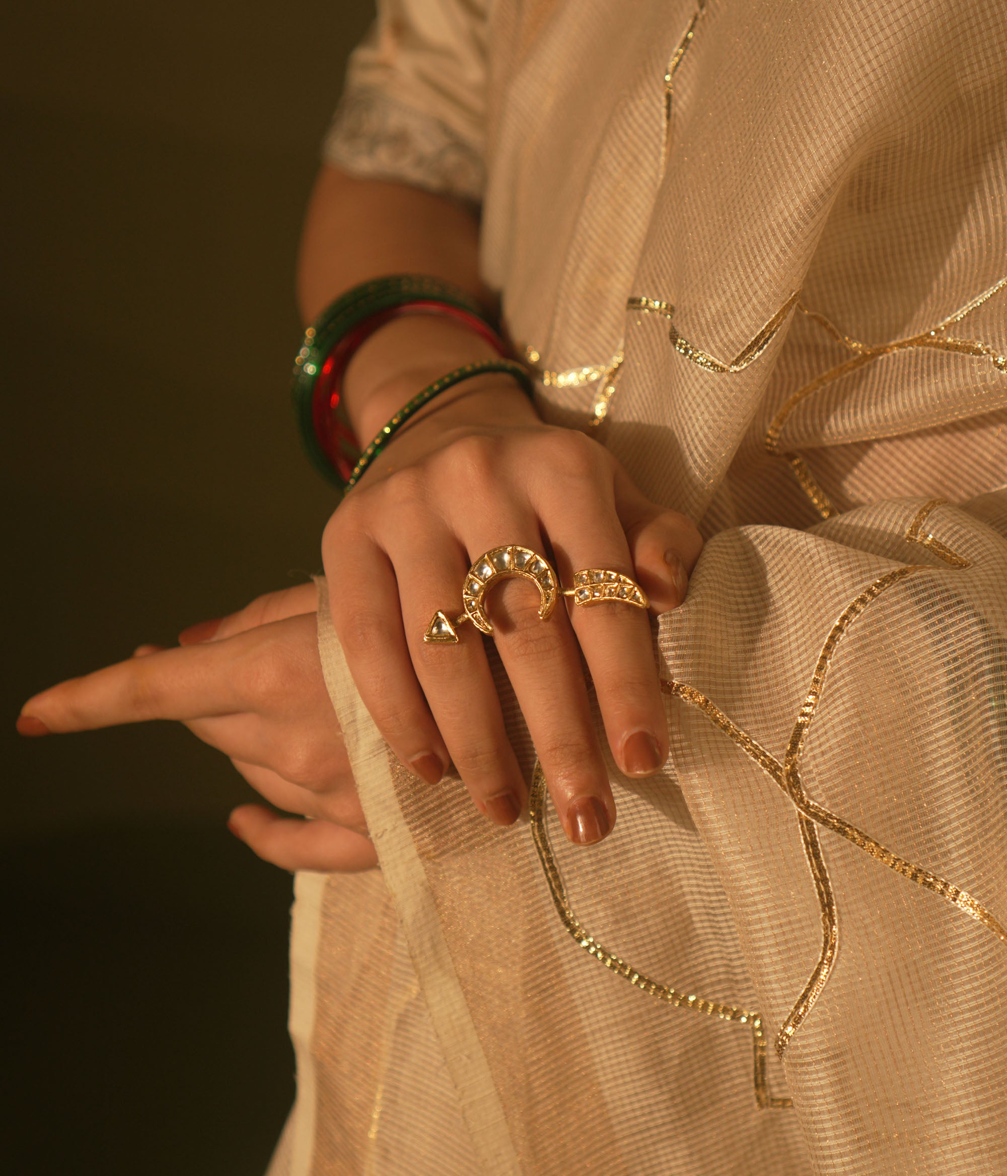 White crescent ring with tusk motif and Kundan sparkles—blending mystery, wisdom, and lunar allure.