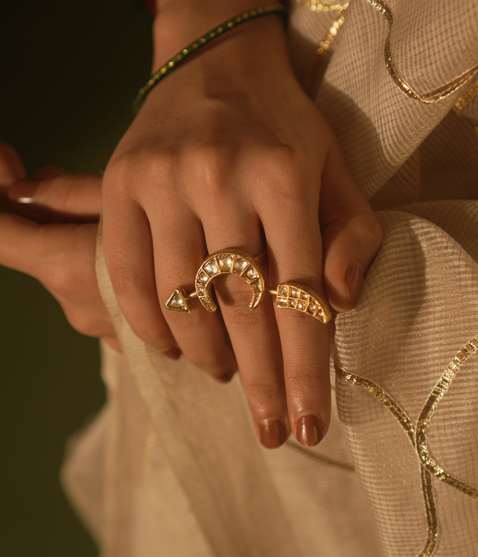 White crescent ring with tusk motif and Kundan sparkles—blending mystery, wisdom, and lunar allure.