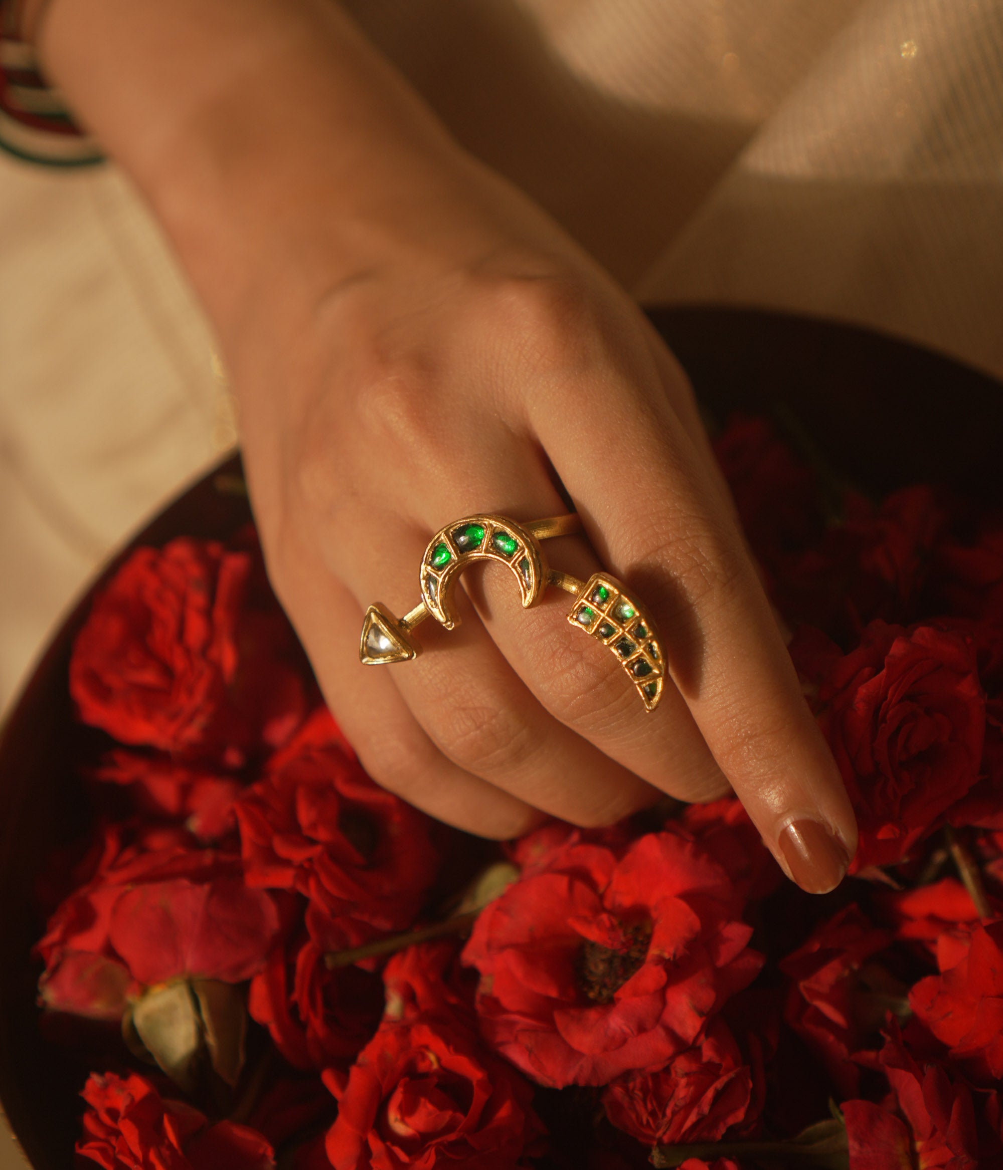 Crescent moon ring with green Kundan and tusk motif—symbolic, graceful, and timeless.