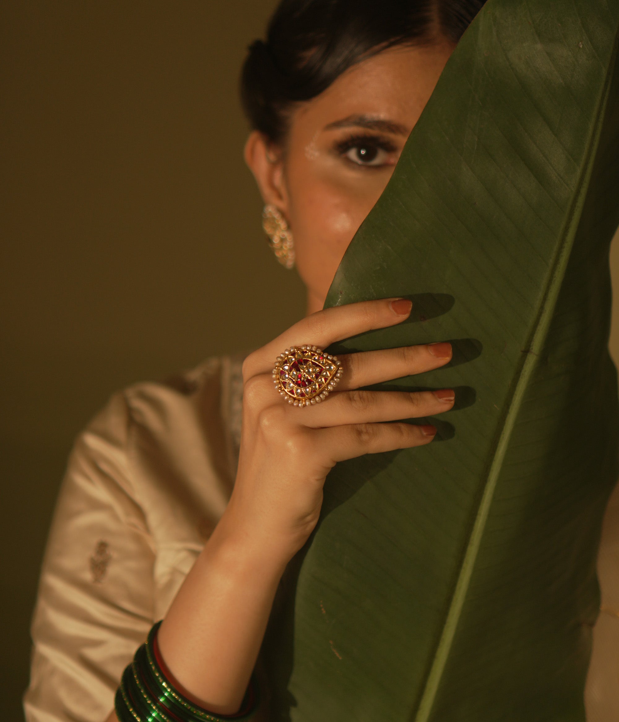  Floral-inspired Kundan ring with pearls—romantic and delicate, a miniature garden of gentle charm.