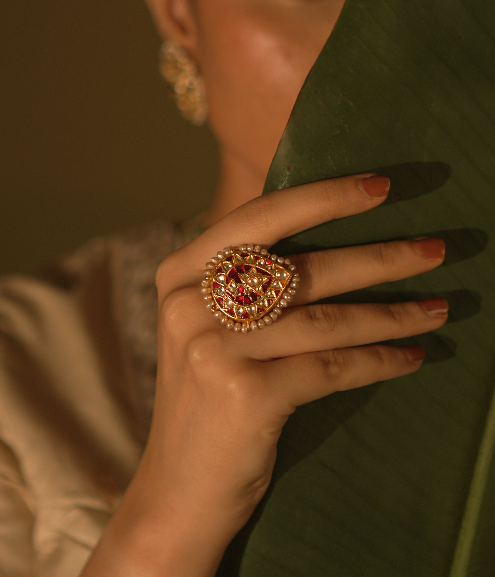  Floral-inspired Kundan ring with pearls—romantic and delicate, a miniature garden of gentle charm.