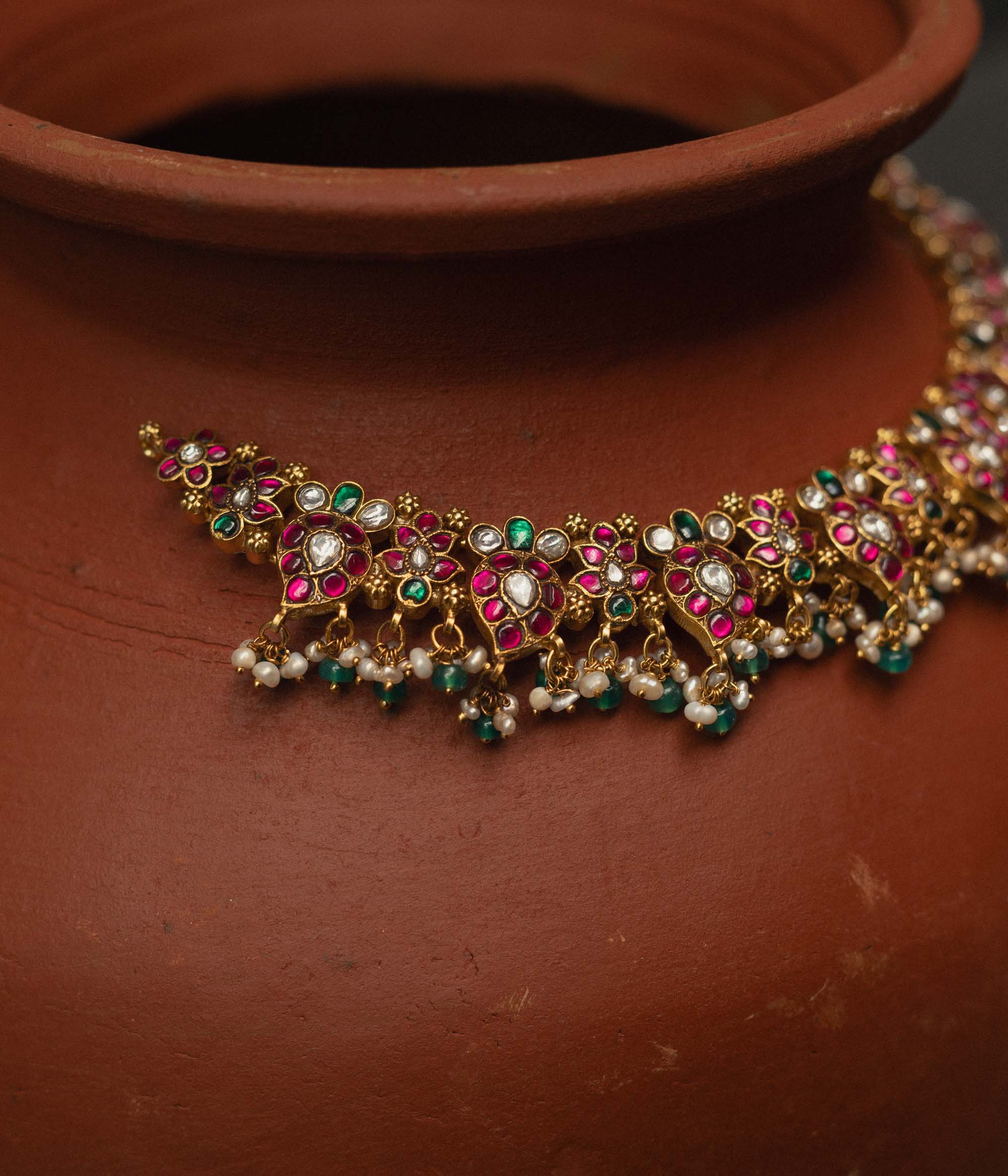 Elegant bridal necklace with pearls, green beads, and Kundan stones

