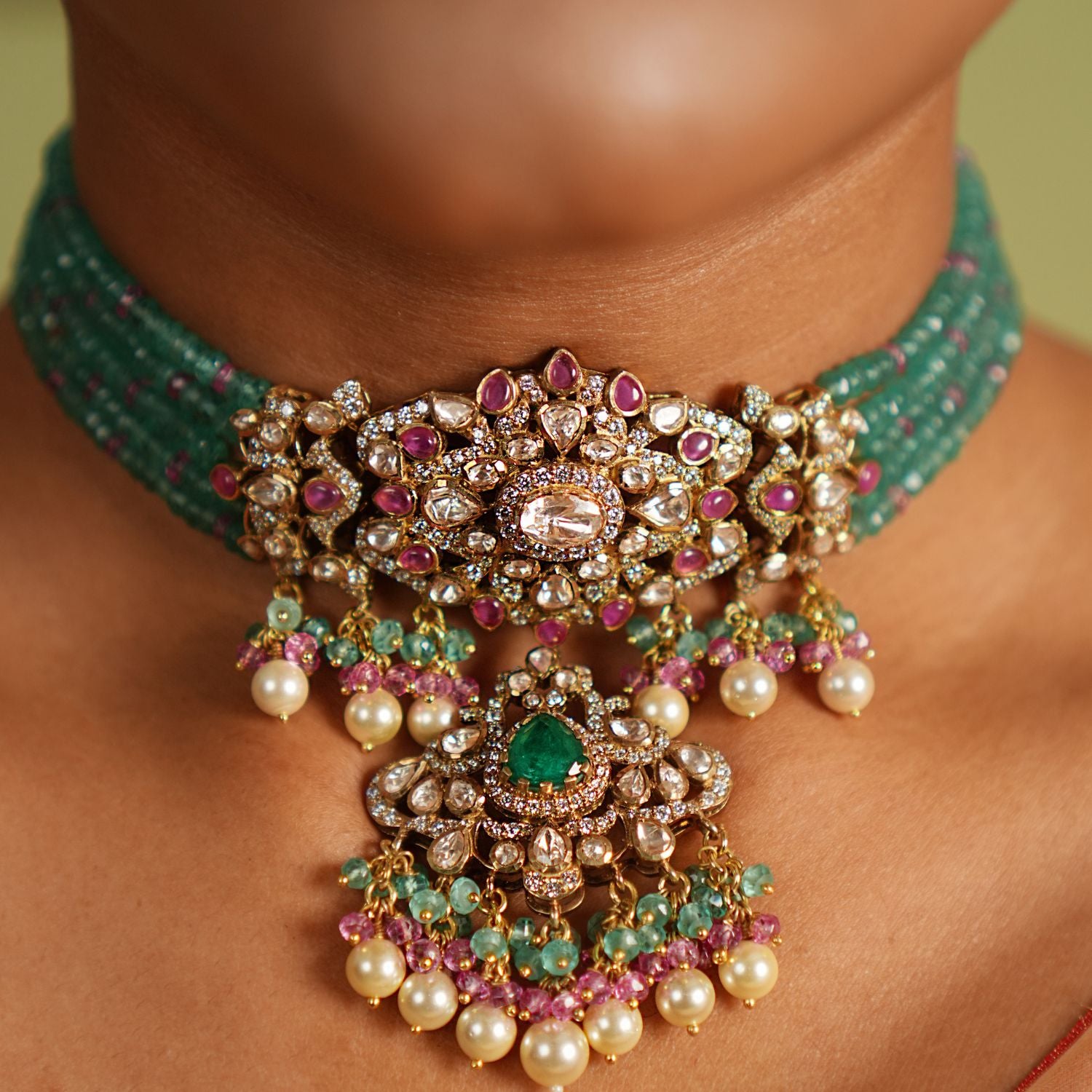 Stunning gold-plated silver choker featuring CZ stones, green jade, pink jade, moissanite Polki stones, and delicate pearls, crafted with an elegant and sophisticated design, perfect for any occasion.