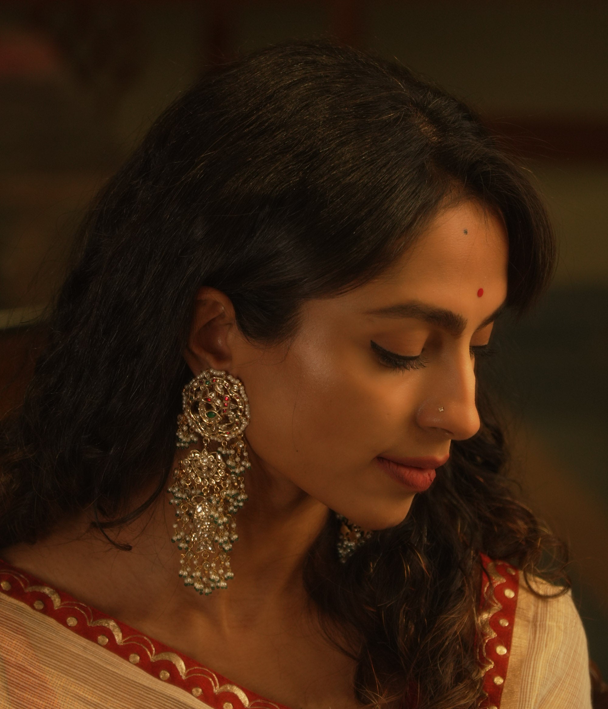Ornate temple-style earrings with rubies, white sapphires, and pearl clusters from the Leelah collection.