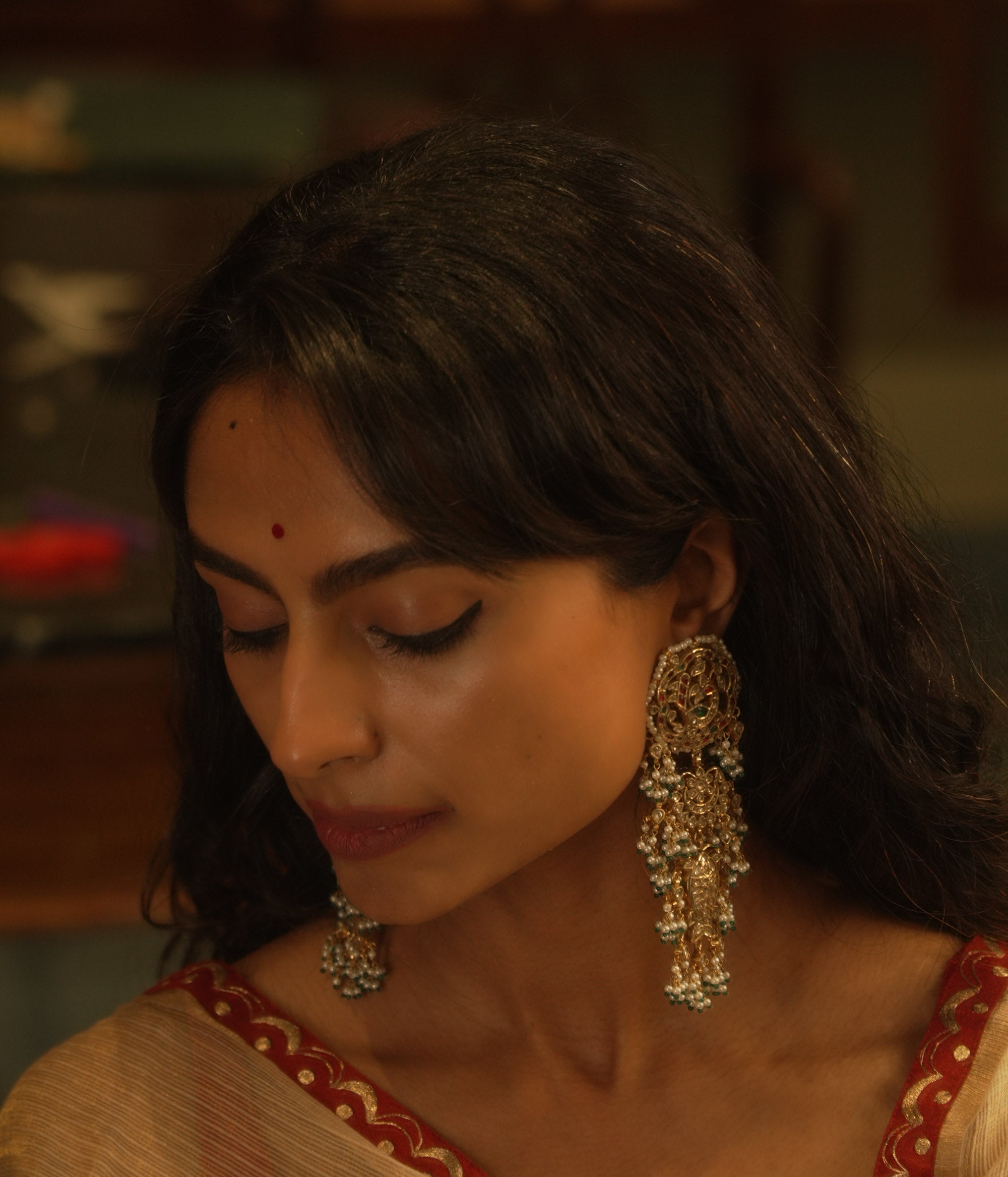 Ornate temple-style earrings with rubies, white sapphires, and pearl clusters from the Leelah collection.