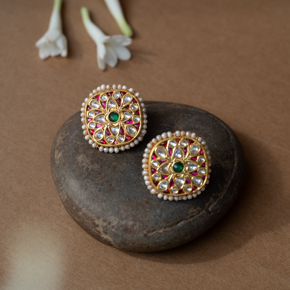 Square gold earrings with ruby, white sapphire petal motifs and a green center from Leelah collection.