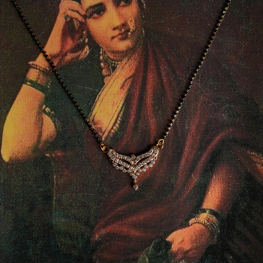 A handcrafted 92.5 sterling silver and 22ct gold-plated Mangalsutra pendant, shining with moissanite brilliance and inspired by vintage Chettinad stone setting, symbolizes marital bliss and blends traditional heritage with modern elegance.