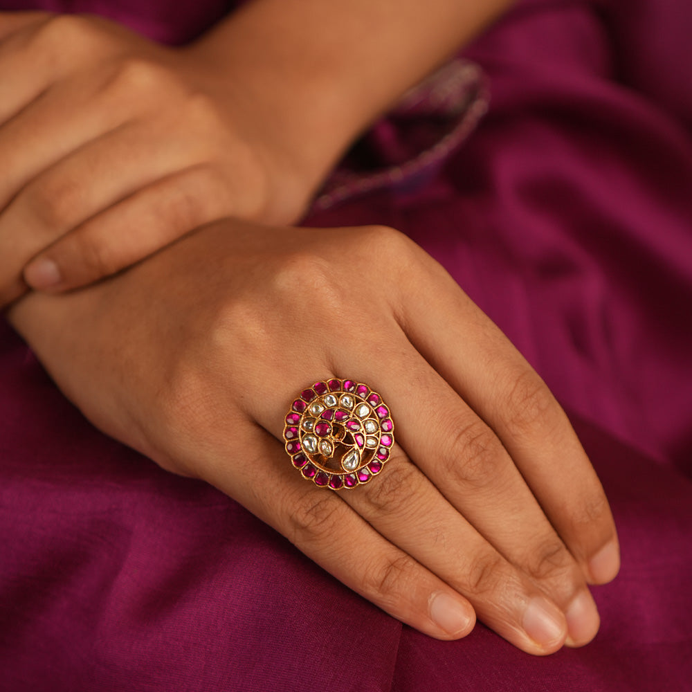 Winged elegance! This bird-shaped Kundan ring shimmers with red and white stones, capturing the beauty of nature in a dazzling embrace.