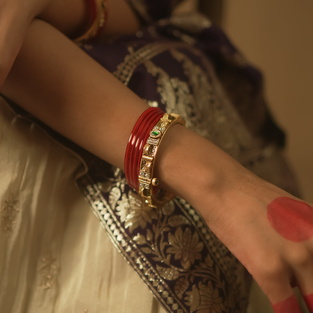 Gold-plated silver bangle with tiny gems and a sunburst pattern.