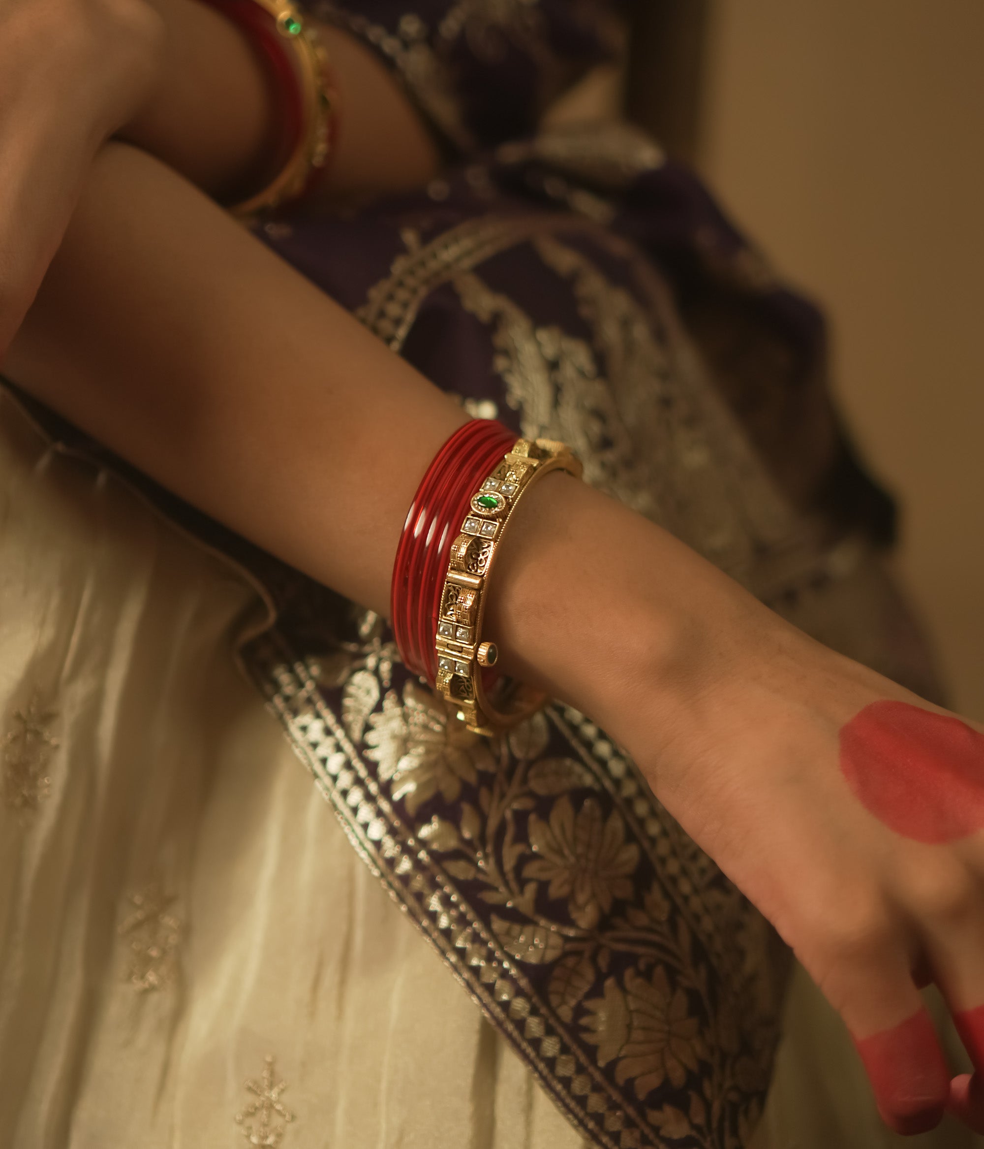 Gold-plated silver bangle with tiny gems and a sunburst pattern.