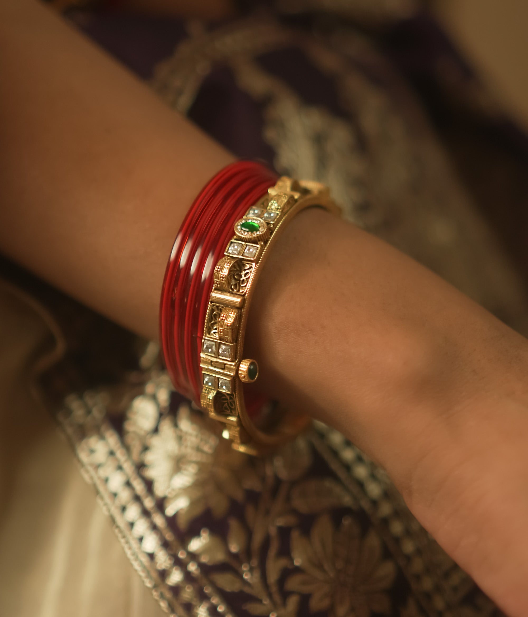 Gold-plated silver bangle with tiny gems and a sunburst pattern.