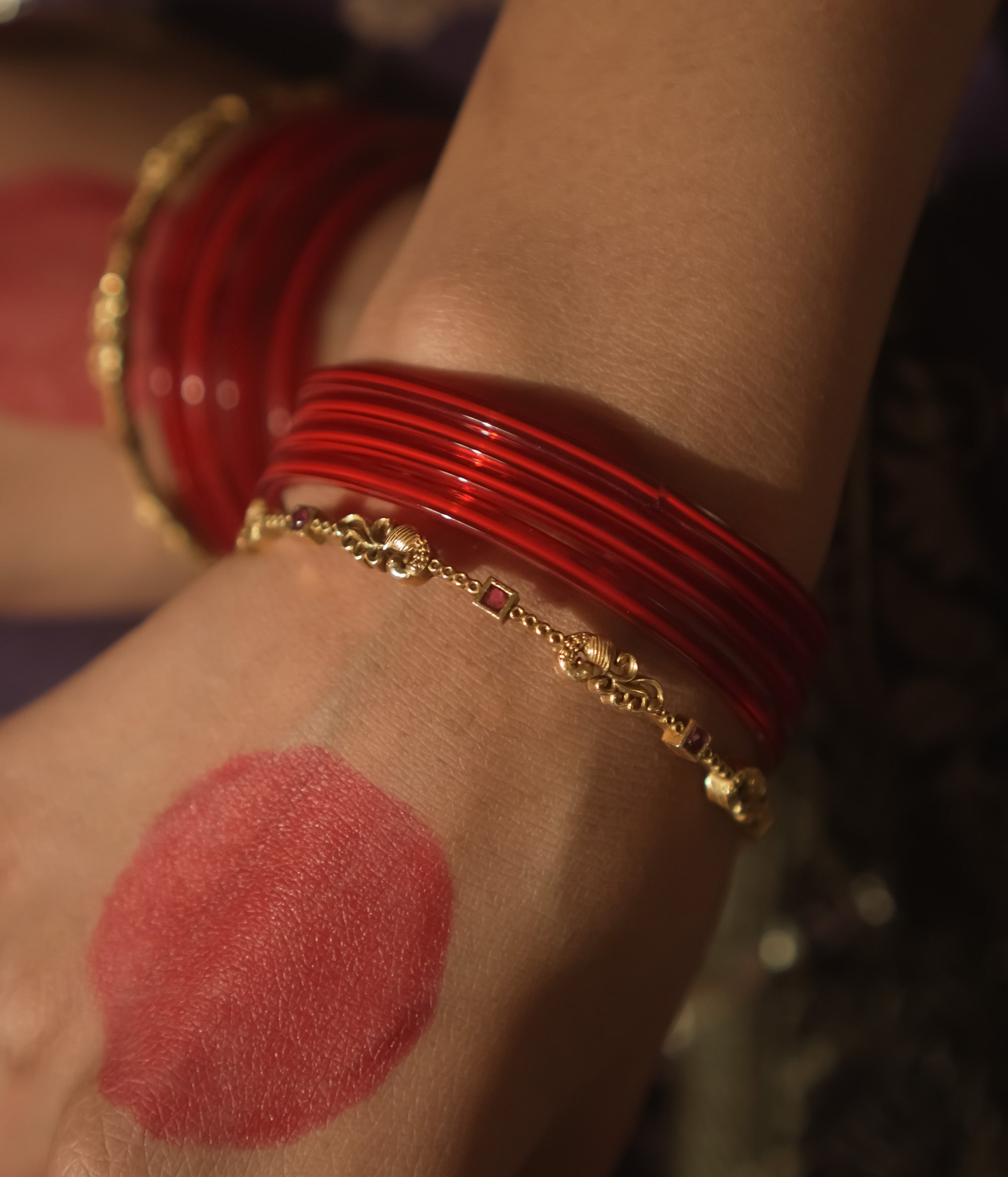 Antique gold-plated silver bangle with crimson threads and links.