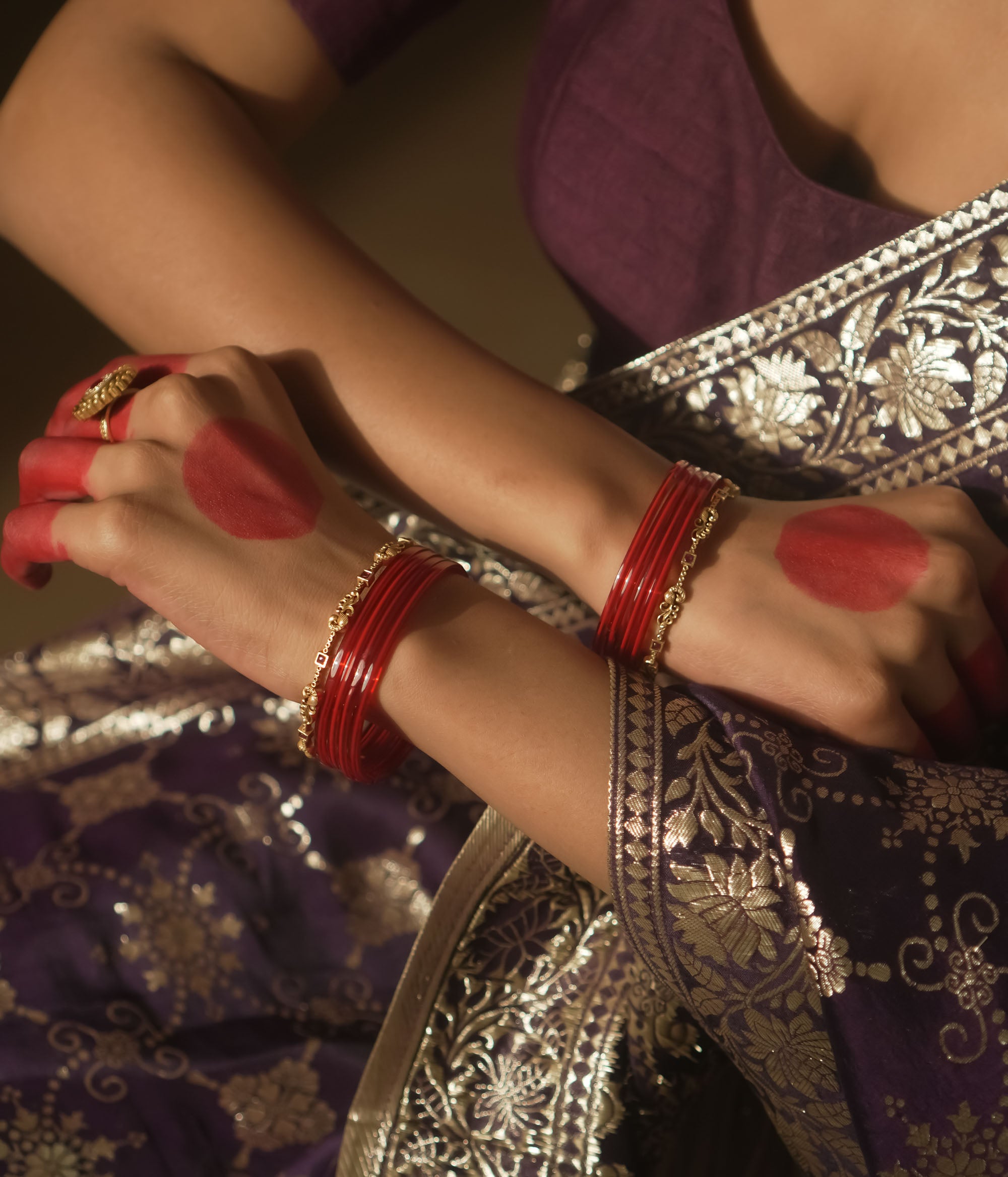 Antique gold-plated silver bangle with crimson threads and links.