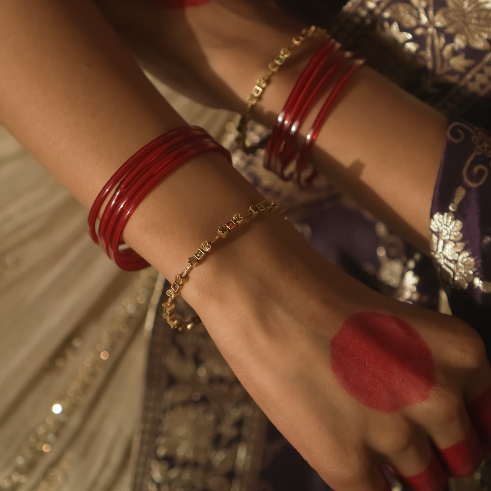 Gold-plated silver bangle with a delicate, twisted chain design.