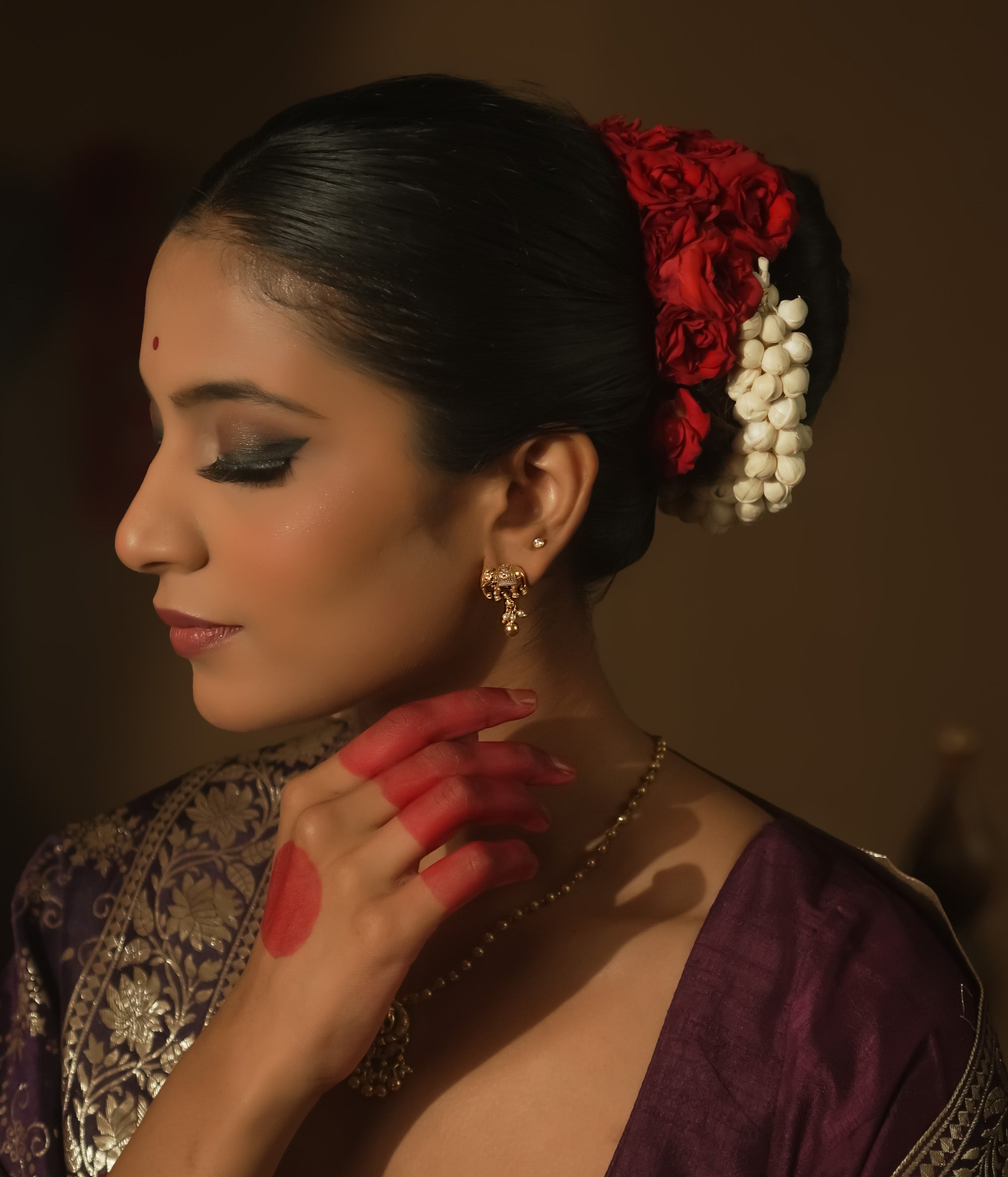 Gold-plated silver earrings with a tiny elephant motif.