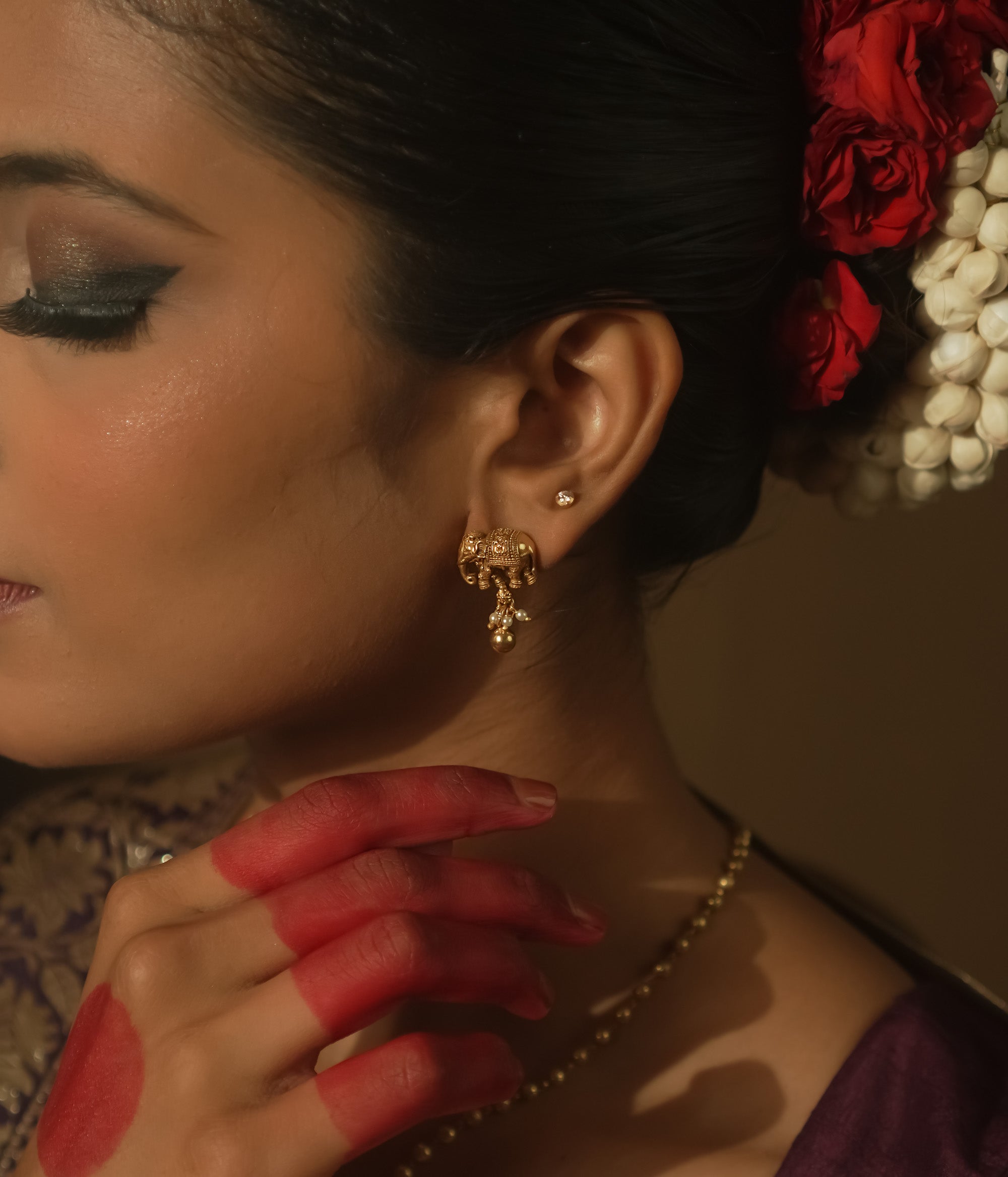 Gold-plated silver earrings with a tiny elephant motif.