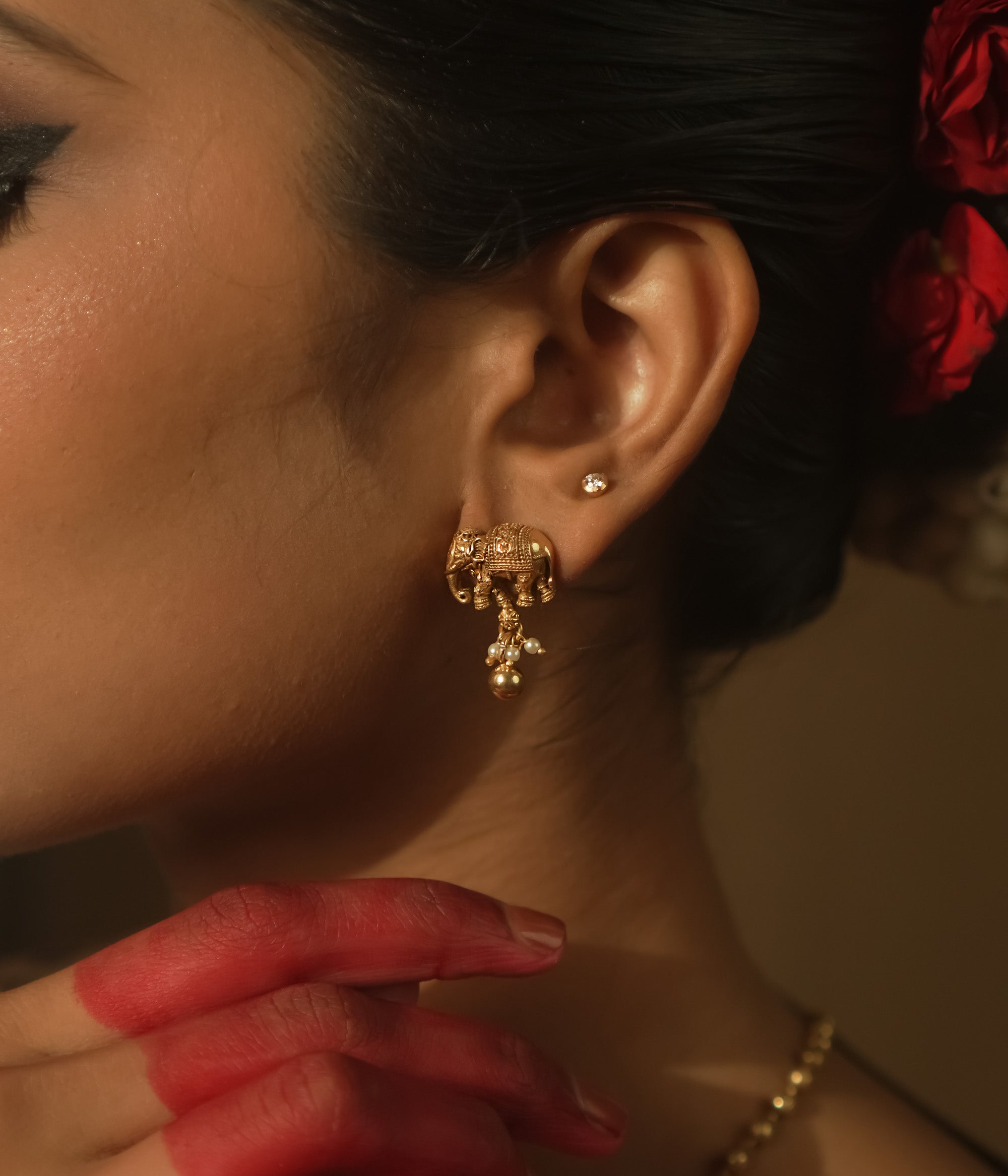 Gold-plated silver earrings with a tiny elephant motif.