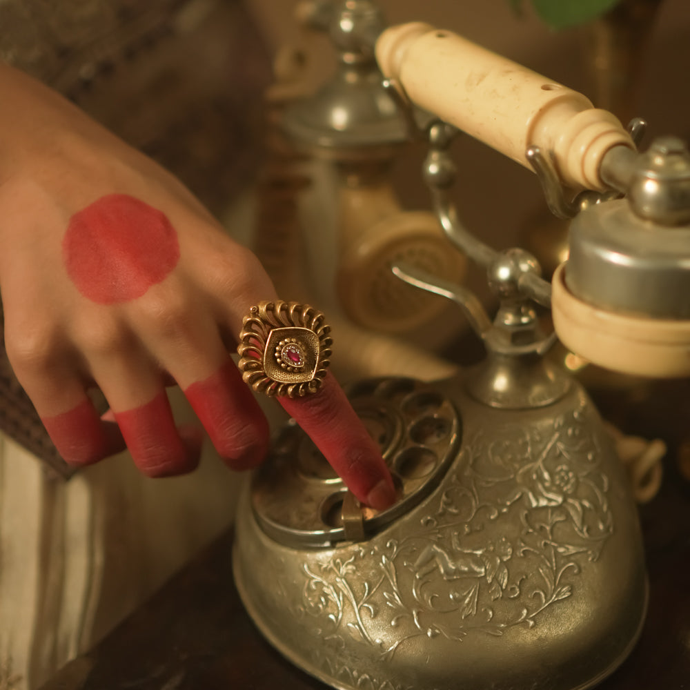 Gold-plated silver ring with a barfi-cut pink gem.
