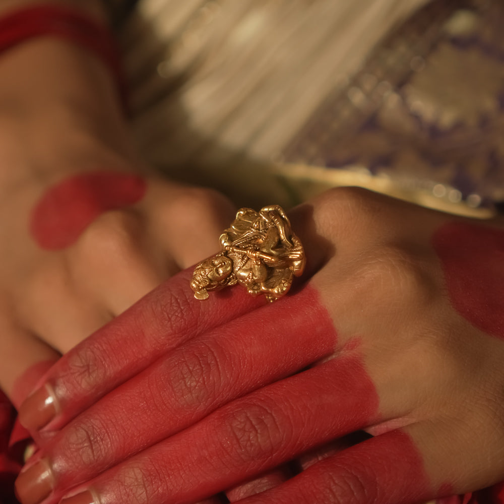Gold ring with a central Baal Gopal (infant Krishna) figure.