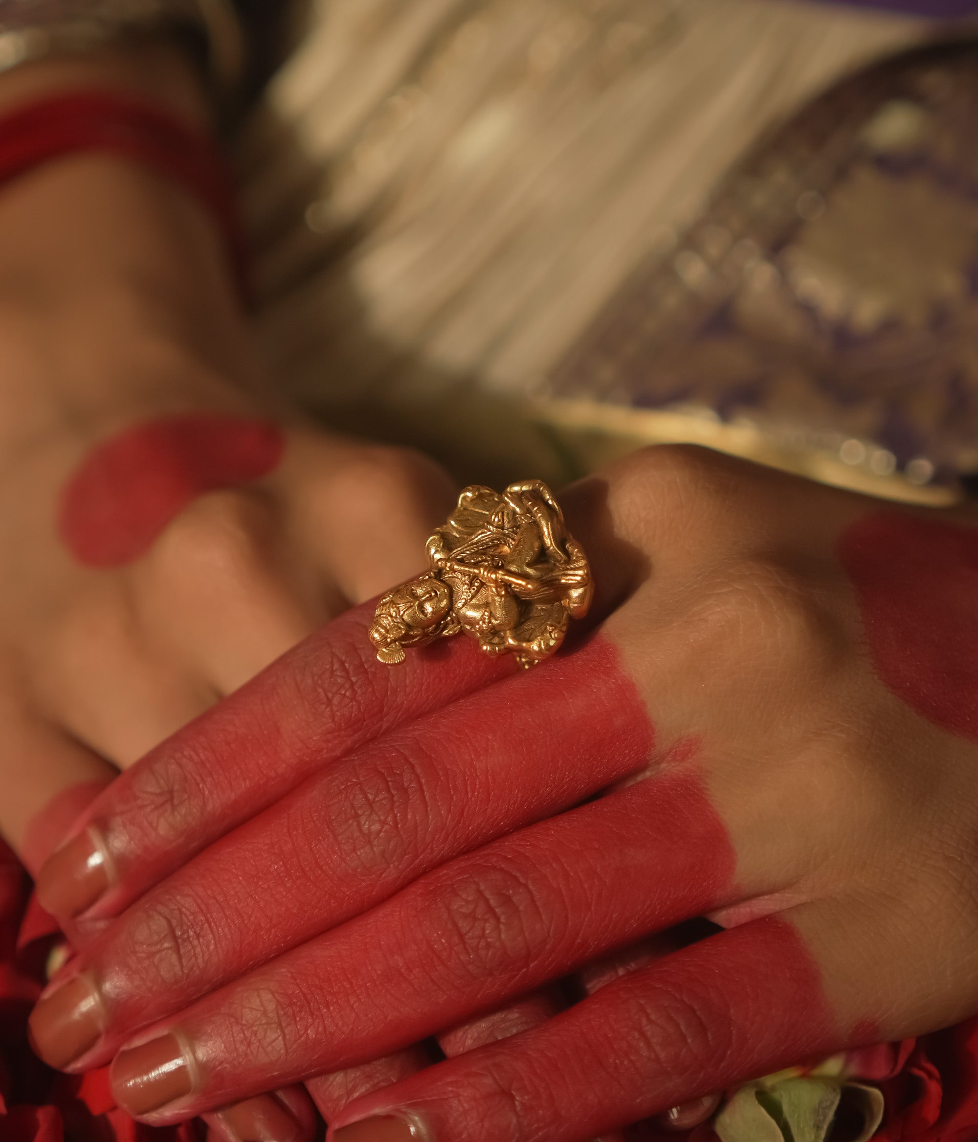 Gold ring with a central Baal Gopal (infant Krishna) figure.