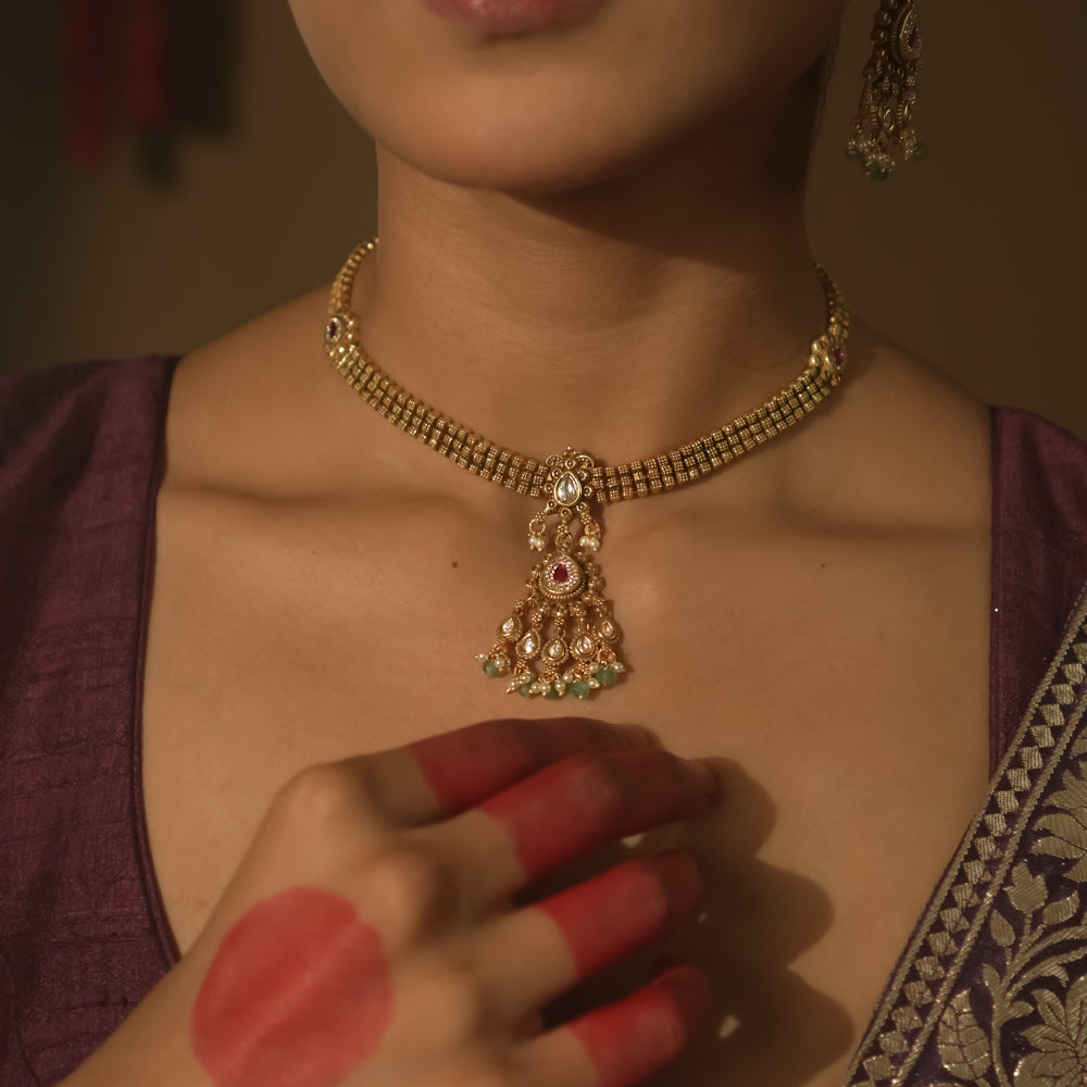 Gold-plated silver mesh necklace with a pendant with rubies, Kundan, emeralds, and pearls.