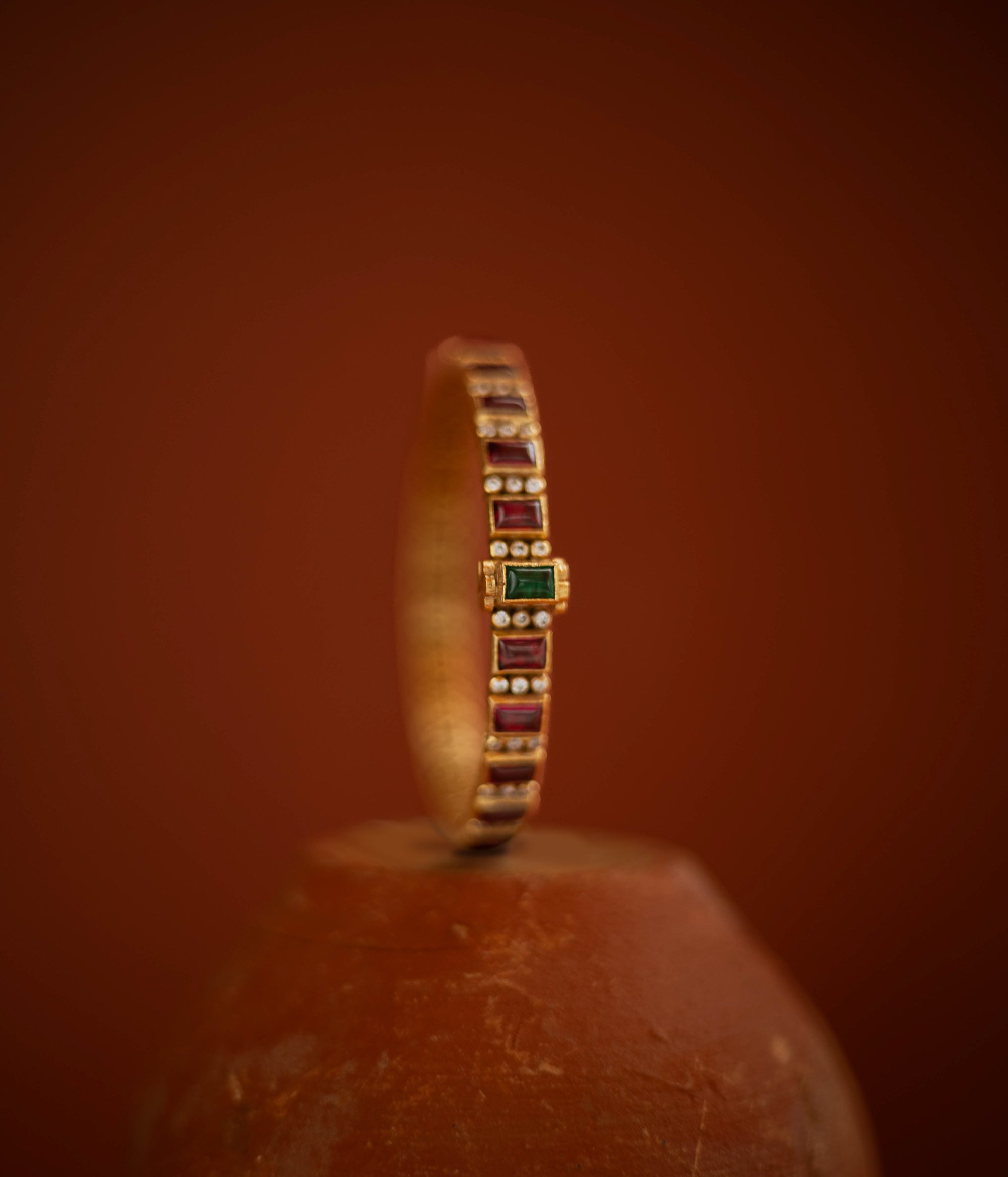  Slim gold bangle with red, green cut stones and CZ accents from Stone collection.