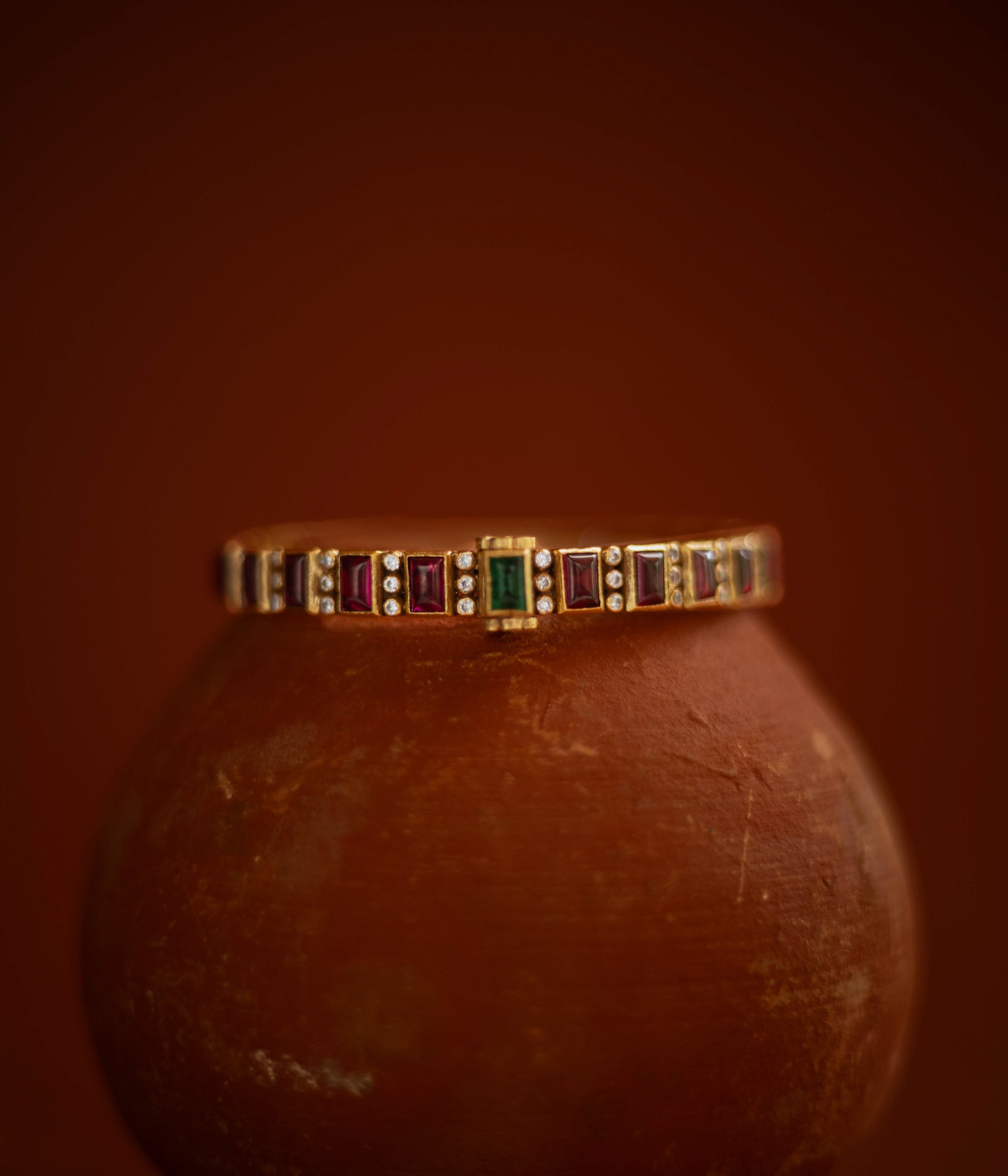  Slim gold bangle with red, green cut stones and CZ accents from Stone collection.