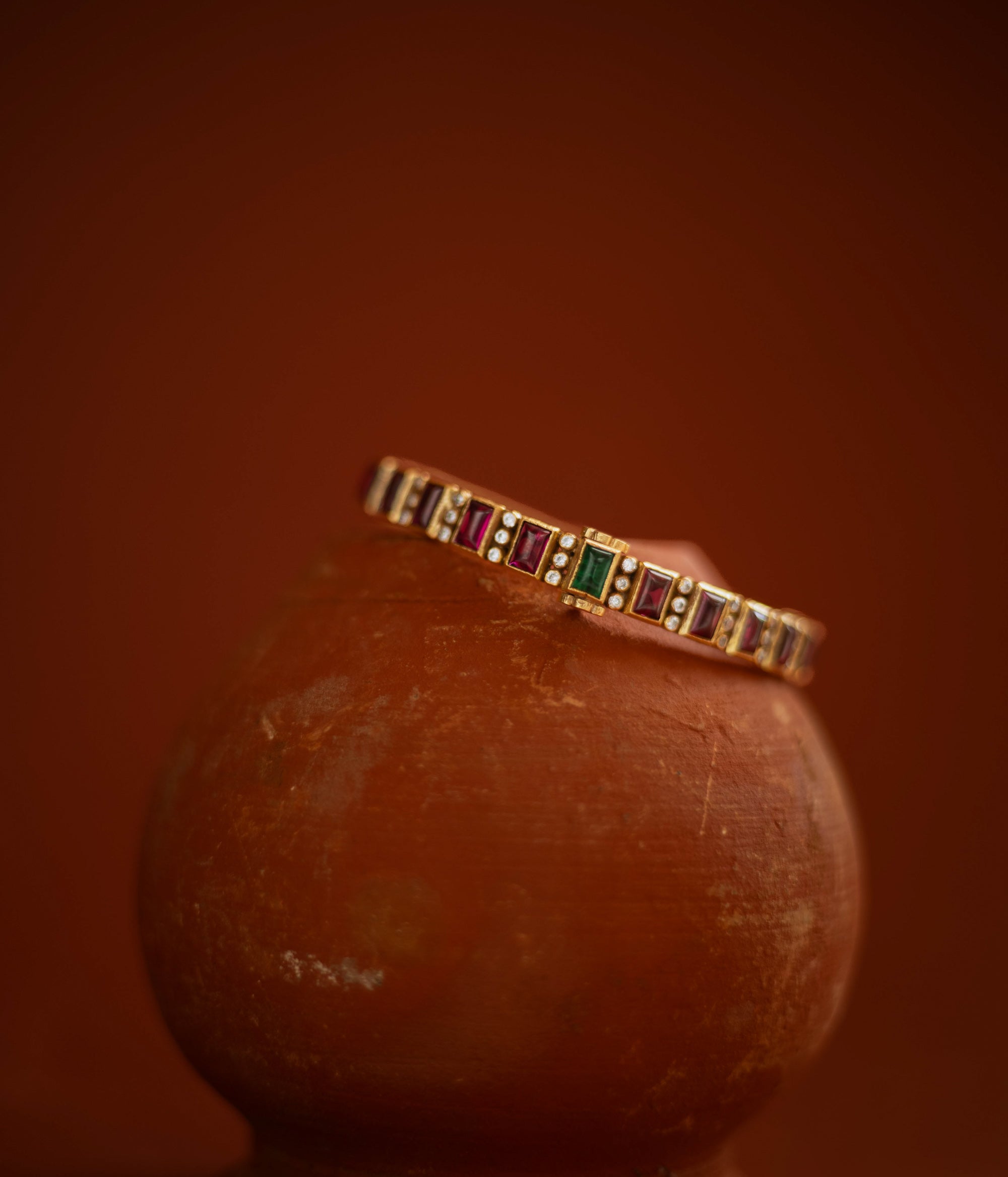  Slim gold bangle with red, green cut stones and CZ accents from Stone collection.