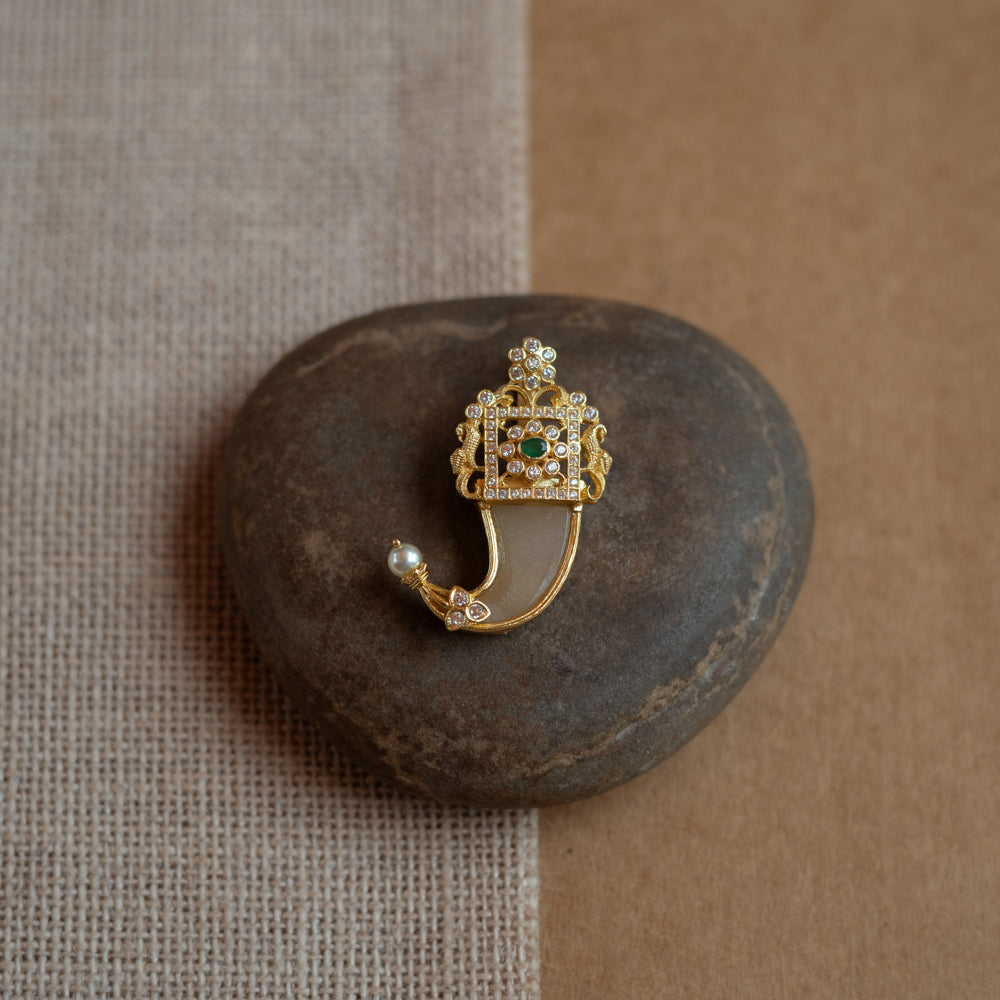 Gold amulet-shaped pendant with a prominent green spinel stone, CZ stones, and pearl drops.