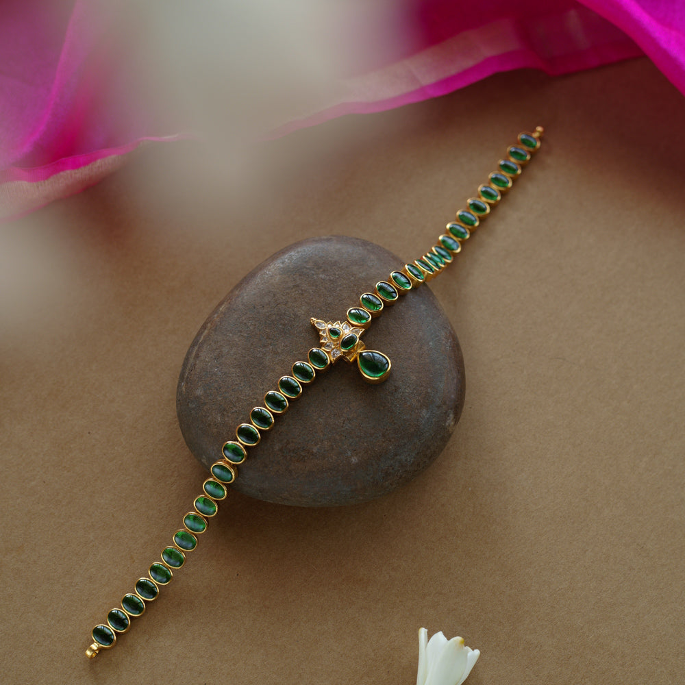 Elegant green stone necklace with center design from Navratna Collection, featuring Swarovski detailing.
