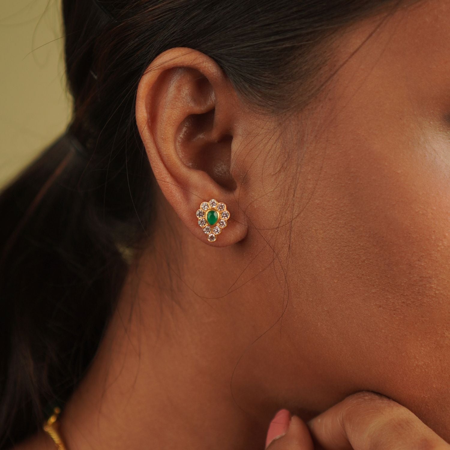Handcrafted in gold-plated silver, these stud earrings blend sparkling CZ stones with a vibrant green gemstone, striking the perfect balance between timeless elegance and playful charm.