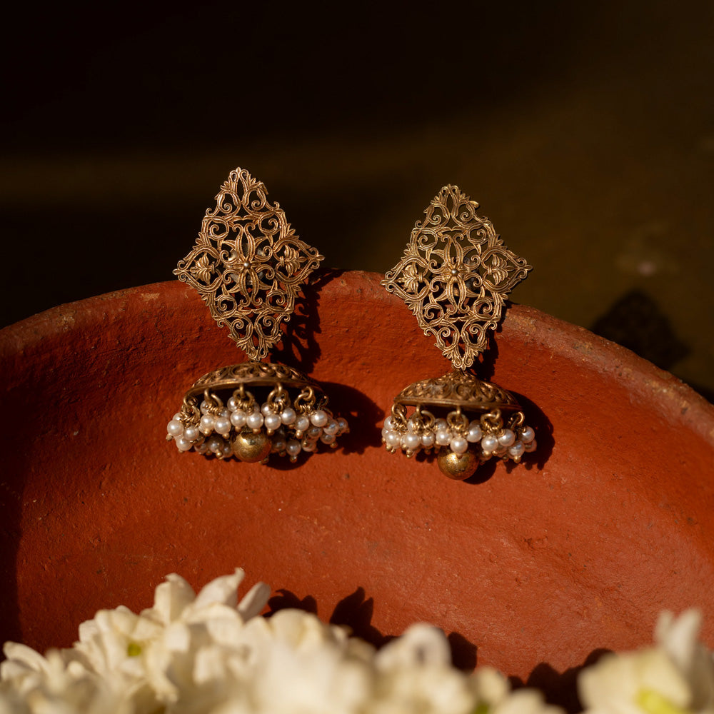 92.5 sterling silver Varnika Filigree Jhumka Earrings featuring intricate hand-carved diamond-shaped filigree and classic jhumka domes adorned with delicate pearl clusters, perfect for understated regal elegance on traditional occasions.