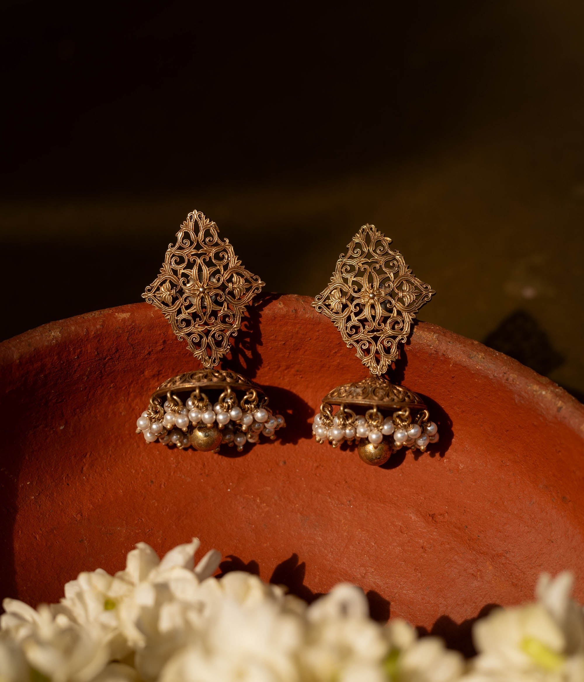 92.5 sterling silver Varnika Filigree Jhumka Earrings featuring intricate hand-carved diamond-shaped filigree and classic jhumka domes adorned with delicate pearl clusters, perfect for understated regal elegance on traditional occasions.