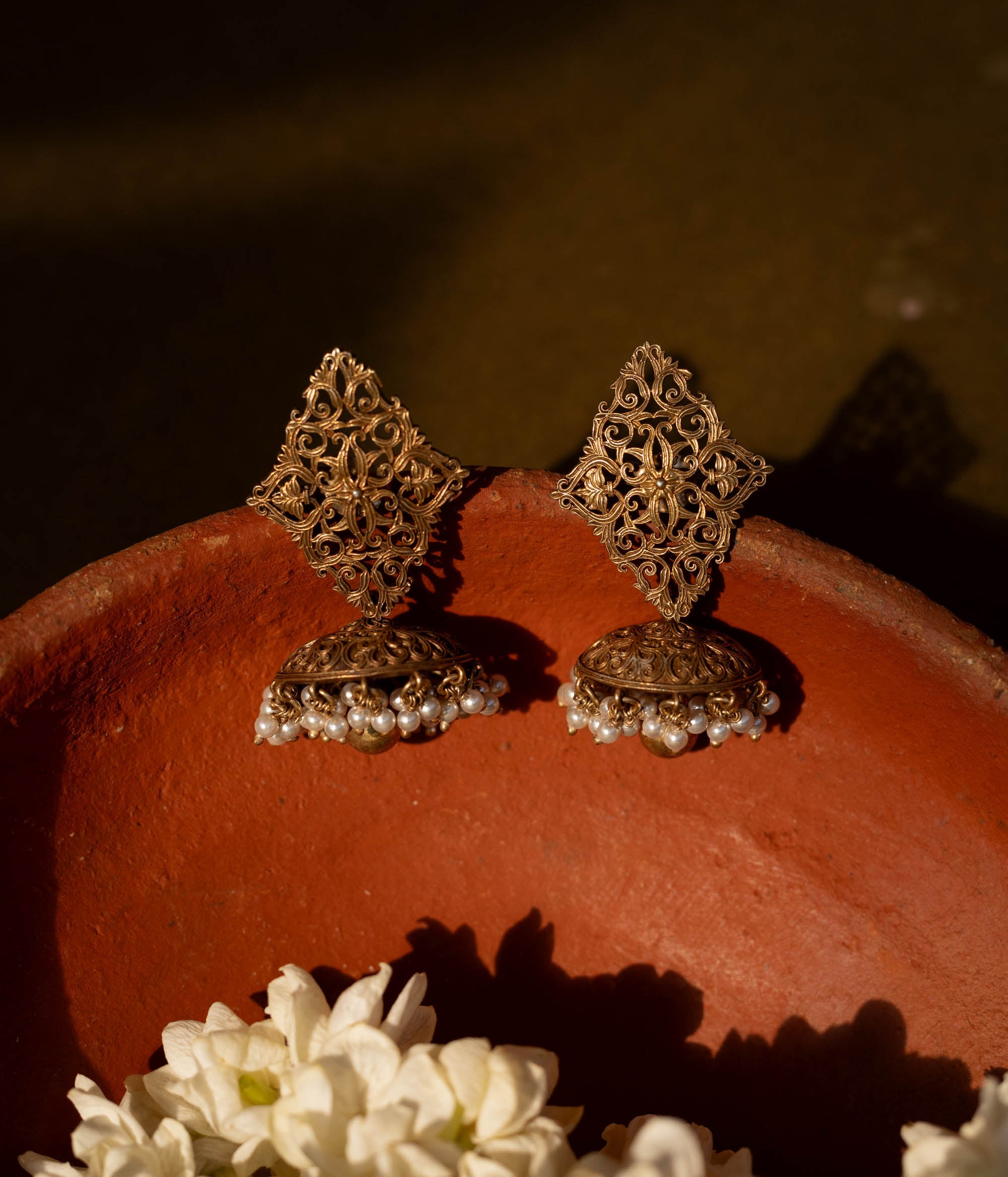 92.5 sterling silver Varnika Filigree Jhumka Earrings featuring intricate hand-carved diamond-shaped filigree and classic jhumka domes adorned with delicate pearl clusters, perfect for understated regal elegance on traditional occasions.